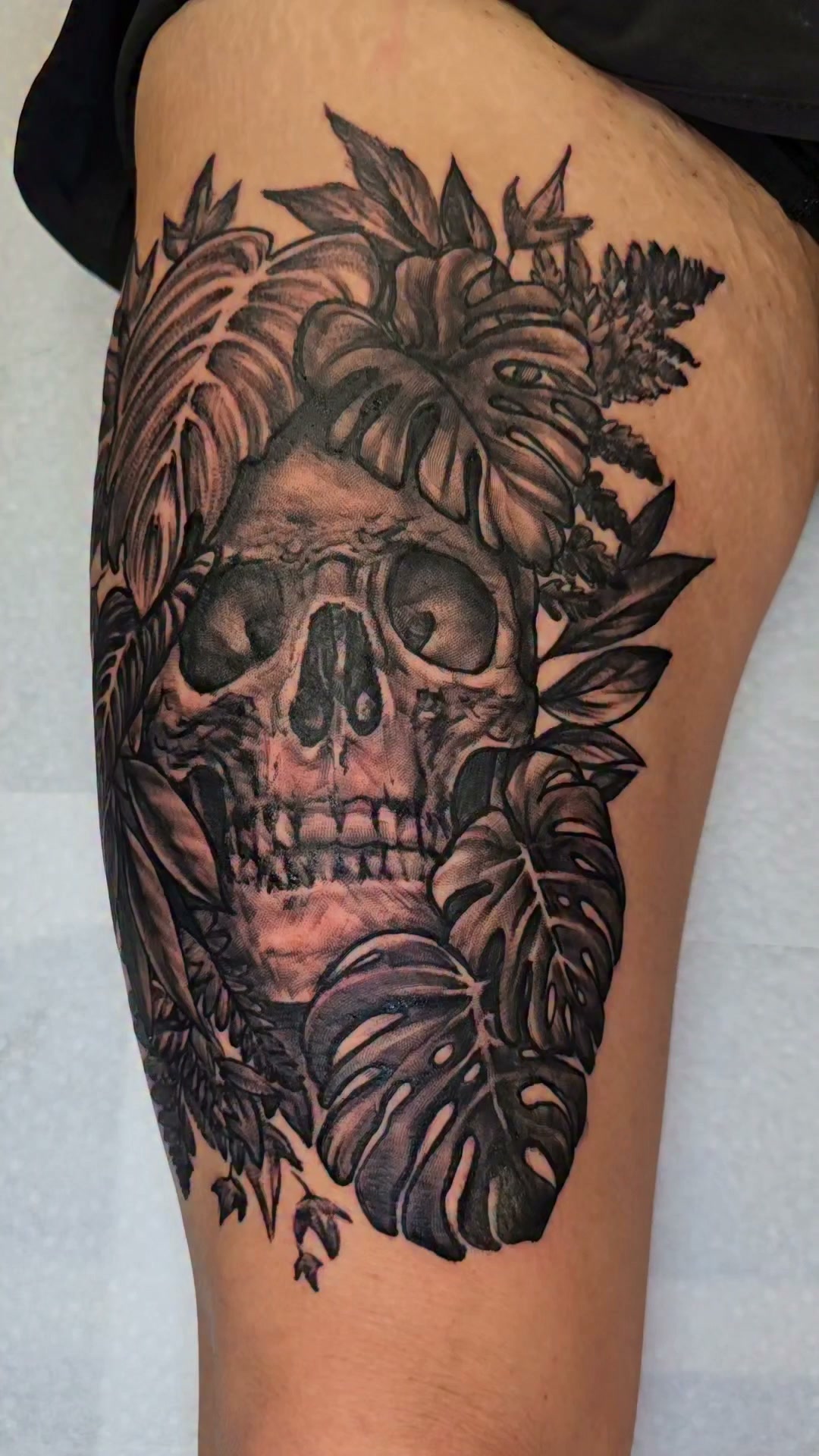 Custom black and grey tattoo of a skull and foliage #mntattooartist #inked #minnesota #bngtattoo #skulltattoo