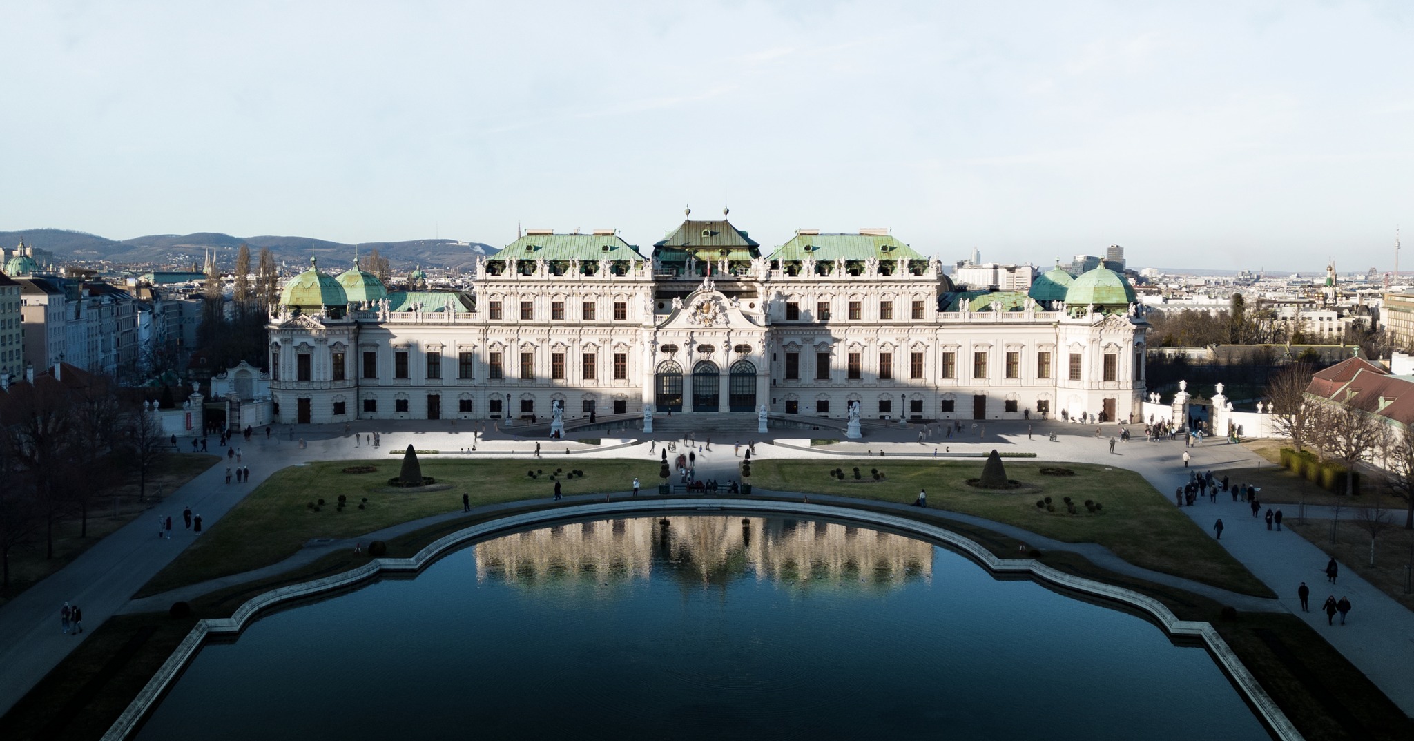 Our contribution to the competition for the new underground visitor centre of the Upper Belvedere.
2024
"An architectural solution in this significant building by Johann Lukas von Hildebrandt can only be achieved through a careful, dialogical approach. Symmetry must be preserved to prevent the interventions, limited to the essentials, from appearing as foreign elements. Connecting the entrances and exits with the building code-required escape routes fulfills this requirement, while simultaneously creating a representative entrance through a gentle, sculptural terrain elevation. Positioned precisely on the edge of the terrain, a relief-like seating step serves as compliant edge protection, harmoniously integrated with the curve of the Belvedere's ramp. Resembling embroidery, it protrudes only 20cm from the park level, remaining barely visible from the southern and western portals and thus preserving the familiar photographic motifs. However, upon approach, the entrance situation becomes increasingly apparent, facilitating orientation without the need for an elaborate signage system.
The interior of the Visitor Center is shaped by an equally symmetrical, spacious hall. Access is granted via the gallery level, providing an axial view of the cascading staircase leading to the Belvedere. A fan-shaped shell construction, originating from the existing vault, creates a visual pull and clarifies the pathway for visitors. The lateral column tracts, spanned by vaulted coffered ceilings, delineate the respective functional areas, accessible via a generous staircase from the gallery after passing through security checks."
#visitorcenterbelvedere
#belvederevisitorcenter #BelvedereMuseum #Research #BelvedereUnderground #PalaceInvitation #ArchitecturalCompetition #DesignInspiration #CulturalHeritage #UrbanExploration #ArtandArchitecture #InnovativeDesign #architecture #vienna