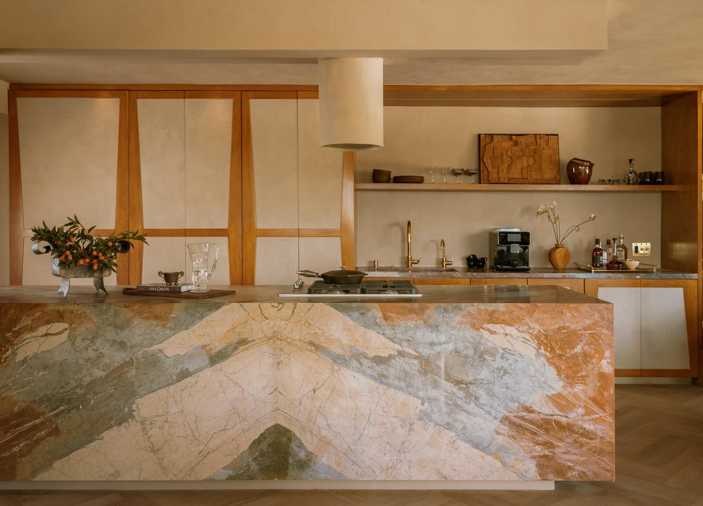 The kitchen at our Voyager project.
I concepted the look of the cabinets first. Since the space is an open concept I didn’t want to see any appliances. I wanted it to feel as warm- if not warmer than the other rooms as it’s the heartbeat of the space. It was intended to feel more like beautiful integrated furniture rather than traditional kitchen cabinets. The frames consist of a honey toned wood and the fronts are all roman clay in the same tone as the walls. What I loved about our marble is that the color has a richness and depth, but still feels a bit faded. I floated the island on a wood plinth so it didn’t feel so blocky and had a little break to the floor. Most of the objects and kitchenware are vintage so it felt more personal to my client.
🤎, Tiffany #nightpalm
Story: @archdigest
Photographer: @pablo.enriquez
Words: @staciestukin
Client: @chasingthedeal
#interiors #romanclay #millwork #design #archdigest #lush