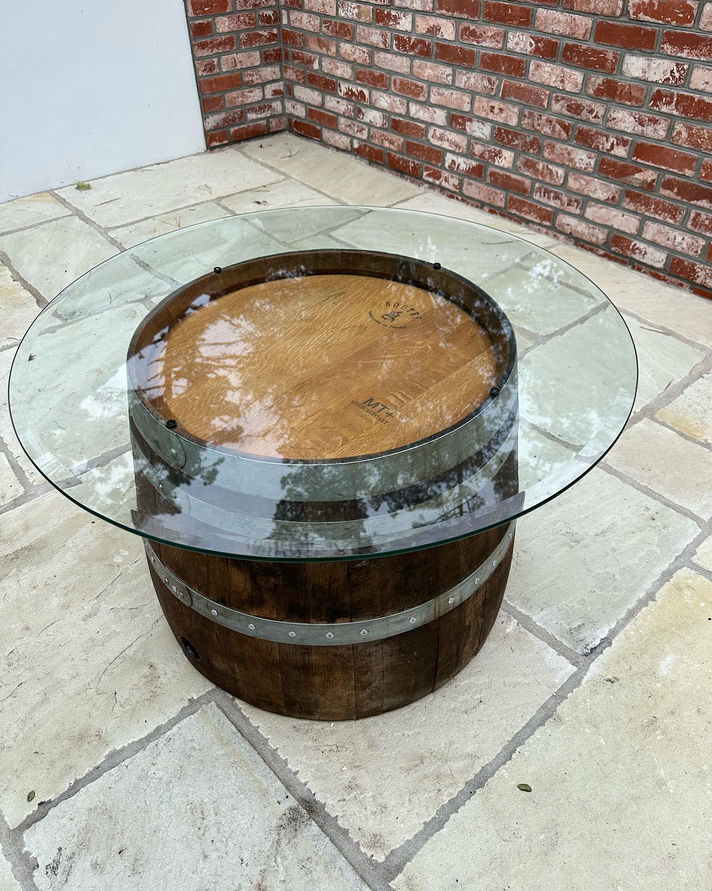 Wine barrel table with glass top.