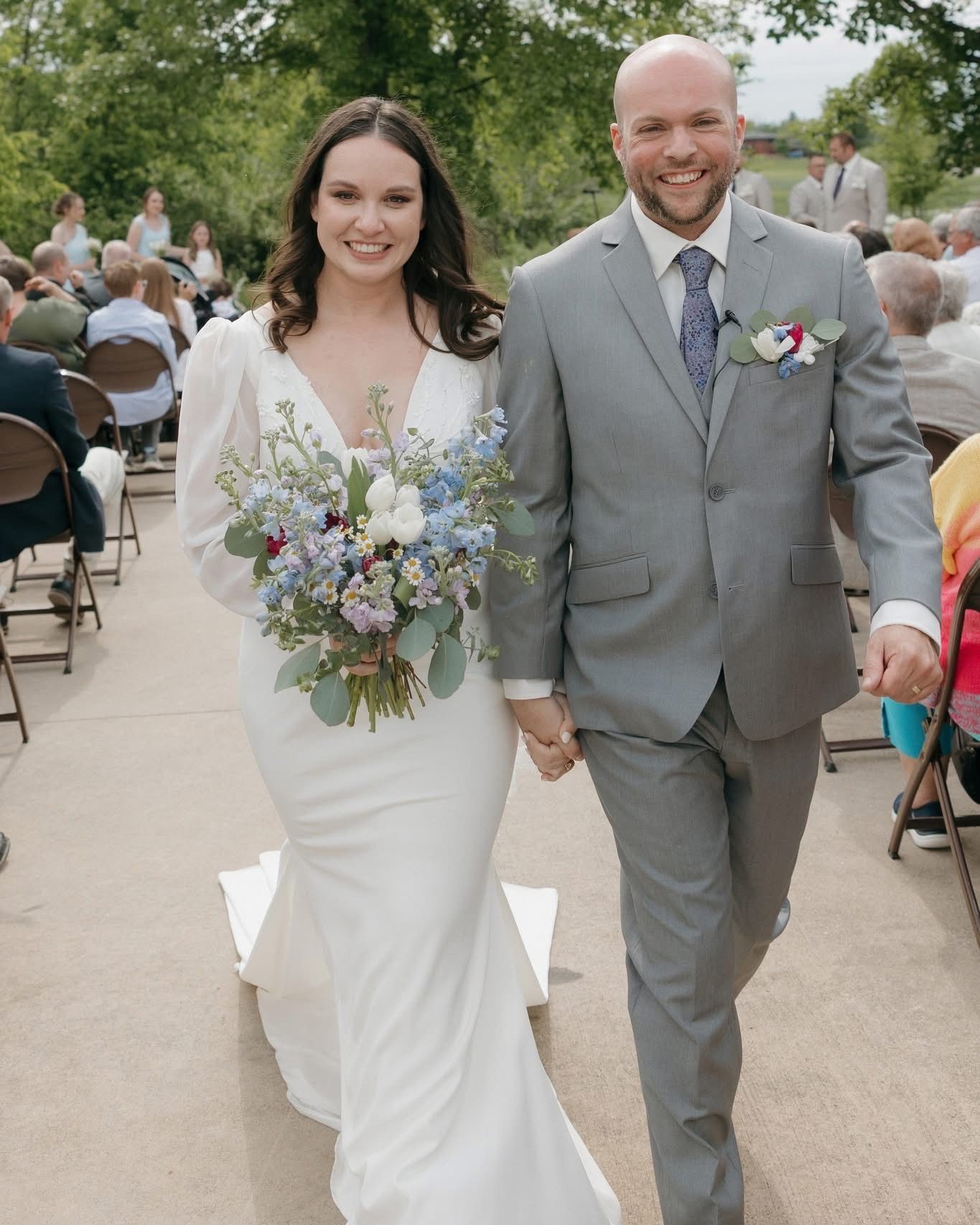 Dani + Jeremy
5.24.25
love story - Jeremy & I met at the public library where I worked downtown several years ago. We had lunch together on one of my breaks, & the rest of that summer was spent seeing each other as much as possible during those 15-to 1-hour intervals. He worked downtown as well, so we would walk down by the river or walk his dog after he got off work, & that's how we got to know each other. We started spending as much time together as possible & talking on the phone every night, & the rest is history.
the dress - My favorite part of my dress...oh gosh, what isn't there to love? I would have to say the sleeves! The puffed shoulders were to die for & flattered my neckline so well since I have more sloped shoulders. The button details on the end of the sleeves were perfect. The plunging neckline was gorgeous without being too risqué, & the button detail along the back of the dress, down to the beautiful train... it was all so perfect & elegant. The best part about it was that I had never considered trying on a dress in this style before because I thought it wasn't "me". But when my stylist pulled it, she, my mom, & I were like, wait a minute, this is actually perfect.
most memorable moment - My most memorable moment was the first look with Jeremy. I had been so anxious & stressed up to the point, but once I saw him, I felt like I could relax & breathe again. I just kept telling everyone, "I'll be better when I get to see him." It made the day a lot more relaxed & enjoyable. The first look & letter reading was very emotional for both of us, but also so full of laughs & love. I don't regret seeing each other before the ceremony whatsoever.
Wedding dress: @marabrides
Photography: @emmasphotoco
Videography: K&K Photo and Film
Food: @popsbbqic + @takethecakedesserts