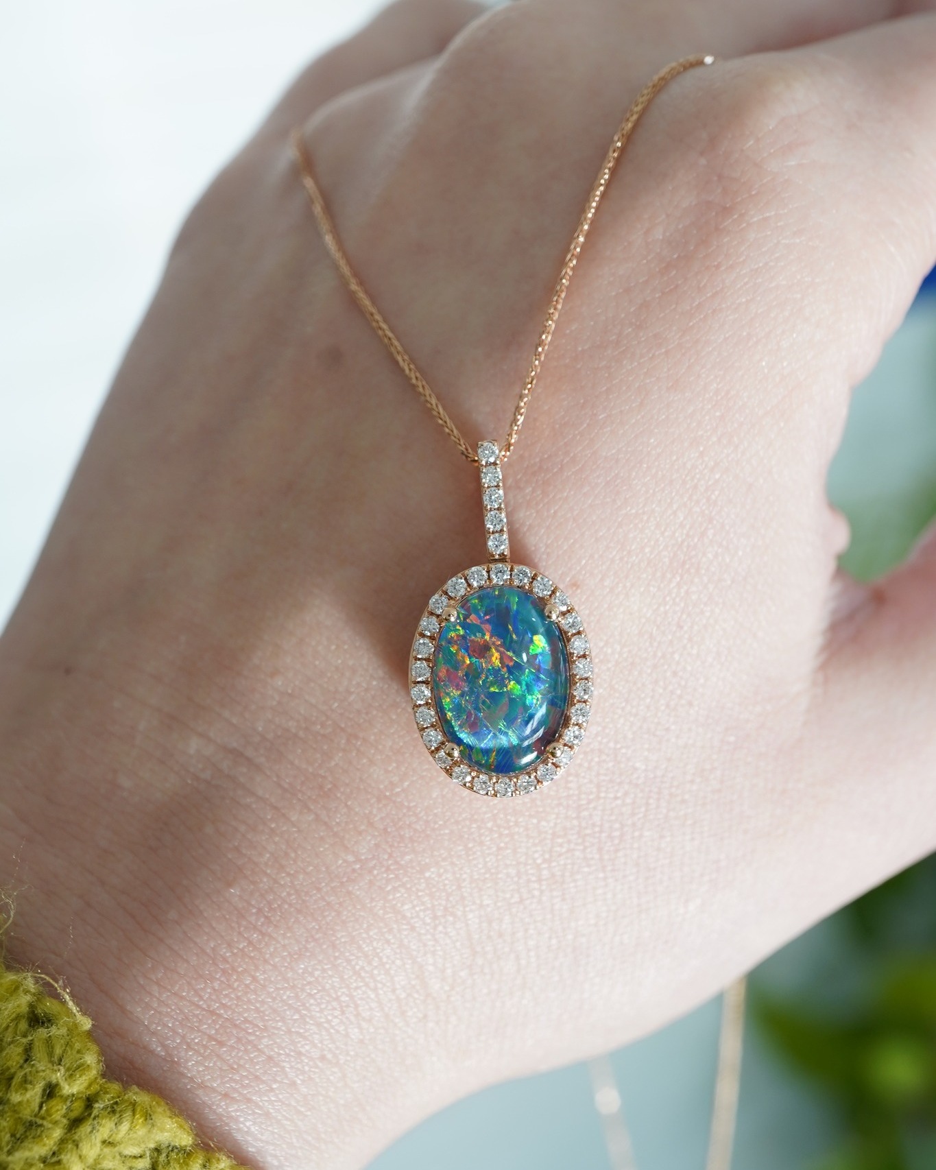 Striking flashes of blue, green, red, and yellow shine throughout this stunning opal necklace. Set in rose gold and accented with .42 ctw of natural diamonds, this piece is sure to captivate. โจ $1395