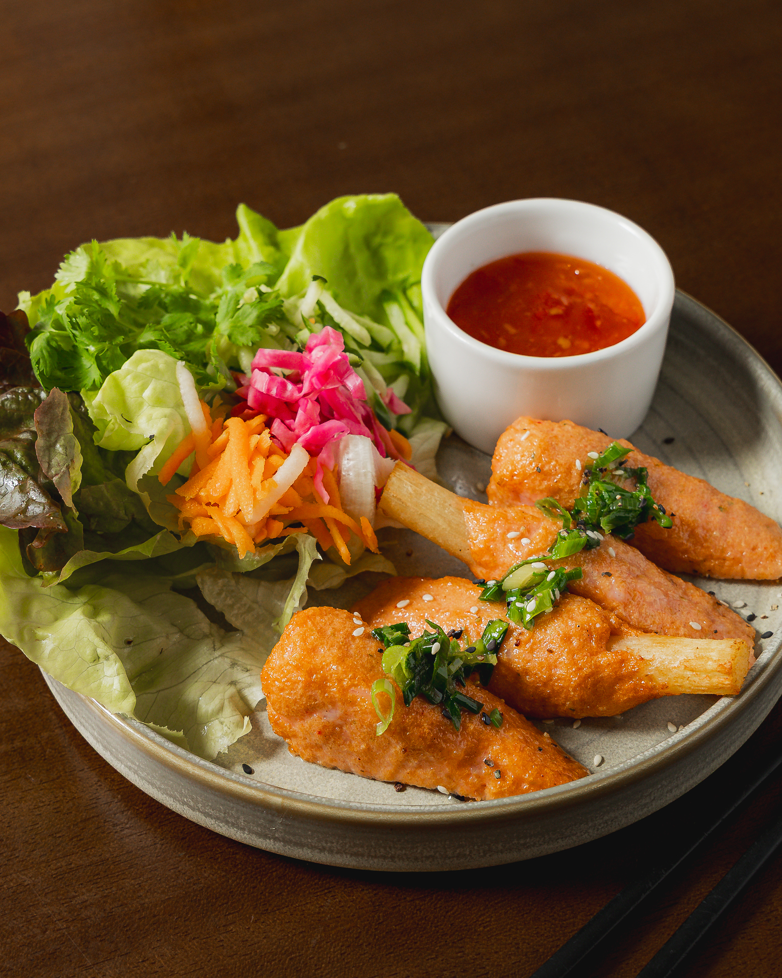 Sugar Cane Prawns (Chạo Tôm)
Take a delicious trip to Central Vietnam with our newest addition.
Originating from the historic Huế region, Chạo Tôm features delicately seasoned shrimp surimi wrapped around a stick of real sugar cane and grilled to a perfect golden brown.
The sugar cane infuses the savory prawn with a subtle, natural sweetness that is absolutely irresistible.
Served fresh alongside our crisp, tangy house pickles and sweet chilli sauce.