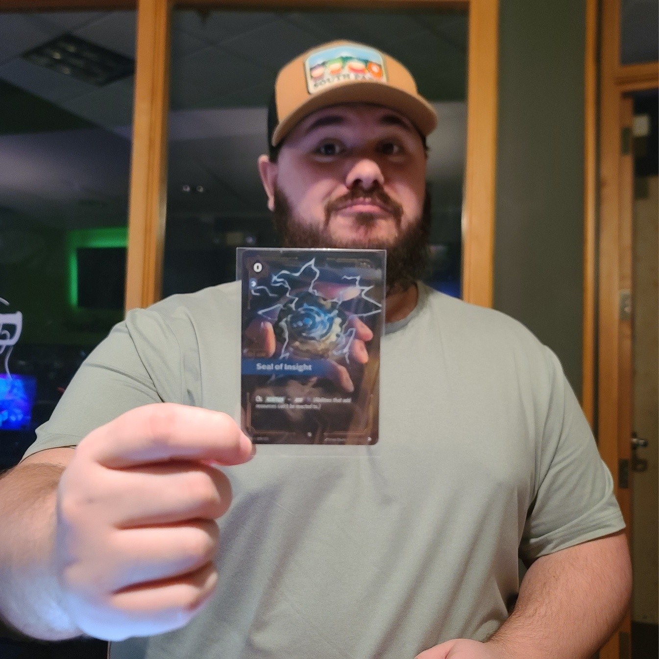 The other day, this fine gentleman grabbed our last 2 packs of Riftbound and pulled this lovely Seal of Insight (that my phone did a dreadful job of photographing). Congrats!
Last night was a late Smash night, so we're opening at NOON today.
It's not this man's fault we're opening late, but we can blame him if you like. 🤷♂️