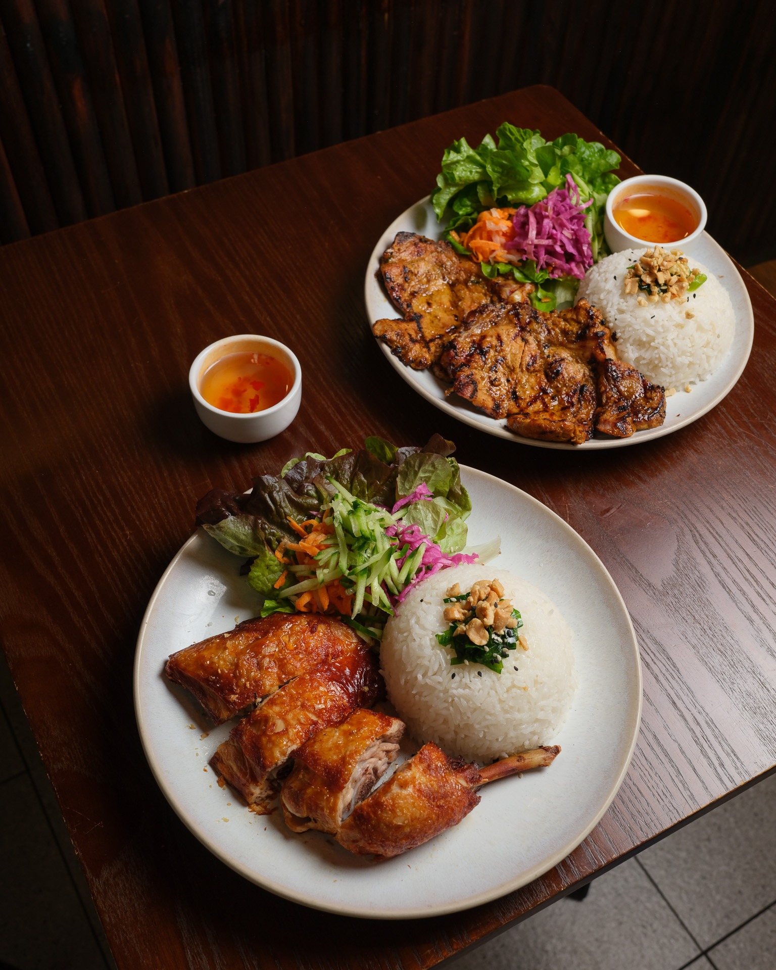 You can't go wrong with our classic Cơm (rice plates).
Choose between our crispy skin chicken or a juicy pork chop.
Every plate comes loaded with fresh salad, crunchy pickles, and a side of sweet nước mắm (fish sauce) to tie it all together.