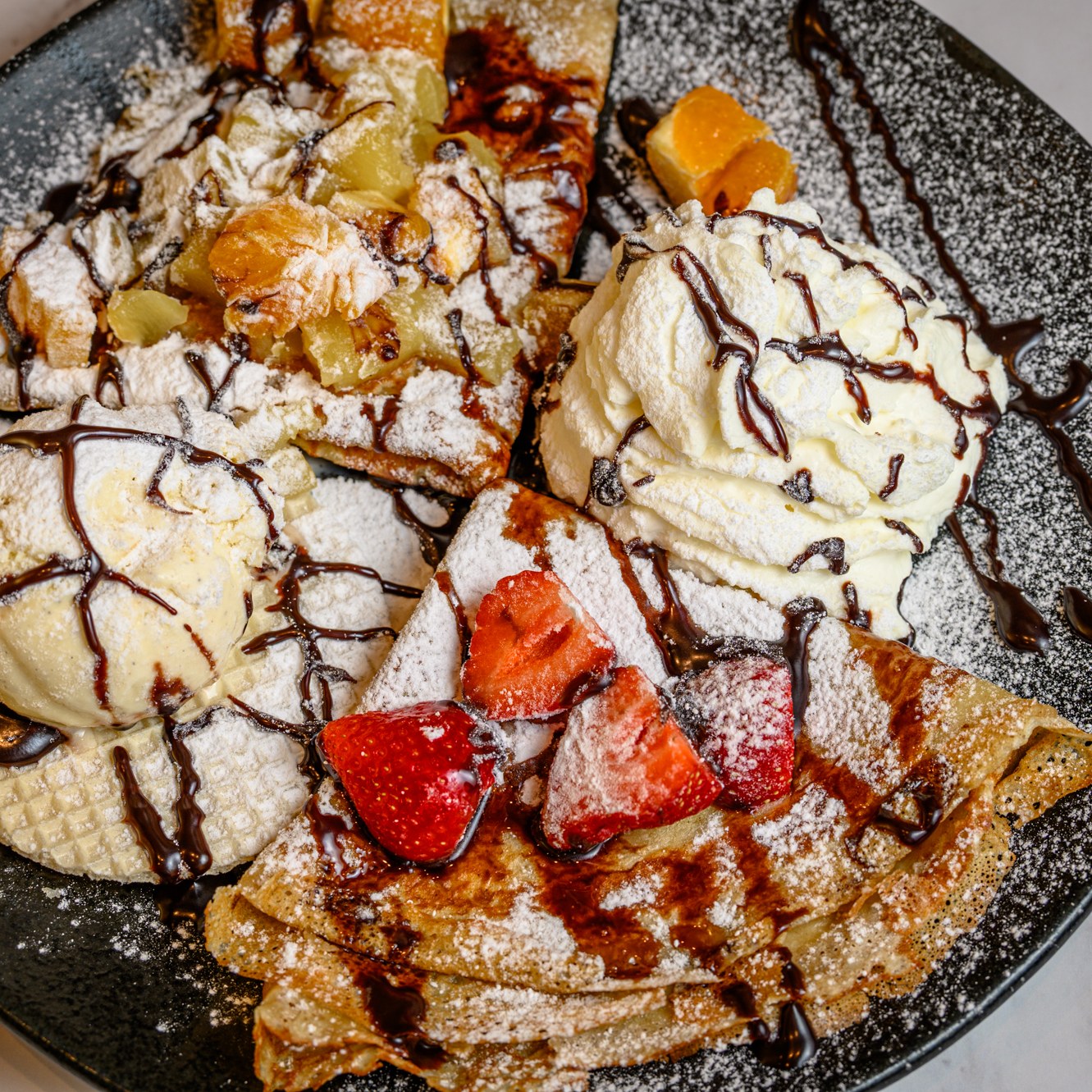 "Sweet Indulgence at L Adresse Blankenberge"
Indulge in the ultimate sweet experience with our heavenly waffles, topped with fresh strawberries, rich vanilla ice cream, and a generous drizzle of chocolate. Perfect for satisfying your dessert cravings!