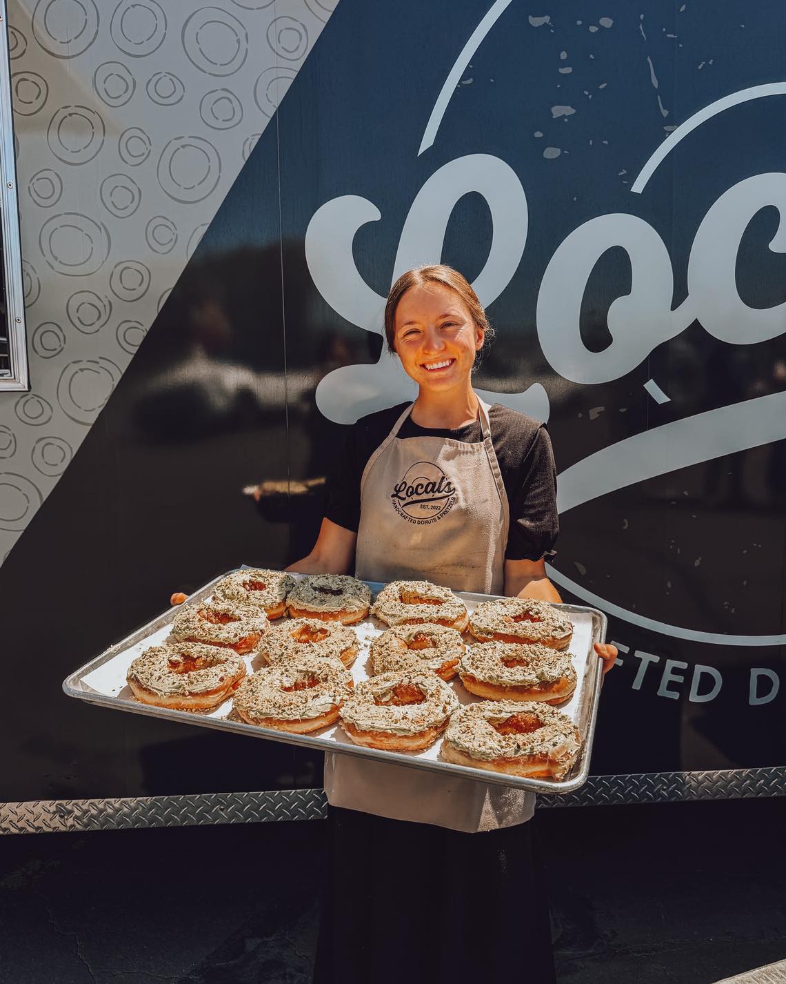 You guys have been loving the Pistachio Cream Donut this week! We thought it would be fun to give a little background on it.
Eric (Locals Donuts owner) has long had the inspiration to create a pistachio donut. We took this idea to Allison (pictured above) and she jumped right it to developing a recipe. Many batches of fluffy green frosting later, the pistachio cream donut was born!
Allison has a gift of connoisseurship. Yes we really wanted to use that word 🤣 But it’s true 😉 She takes time to distinguish subtle flavors and tweak recipes. We are so grateful for her hard work on this donut special. 🫶
The Pistachio Cream Donut is an original glazed donut topped with a fluffy Pistachio buttercream, made with real pistachio butter! We then add crushed pistachios and kataifi on top for an added crunch!
Fun fact: The lovely green color of the frosting naturally occurs from the pistachio butter and pandan leaf used in it.
Have you tried the pistachio donut yet? Give it a rating below!!!! 😁