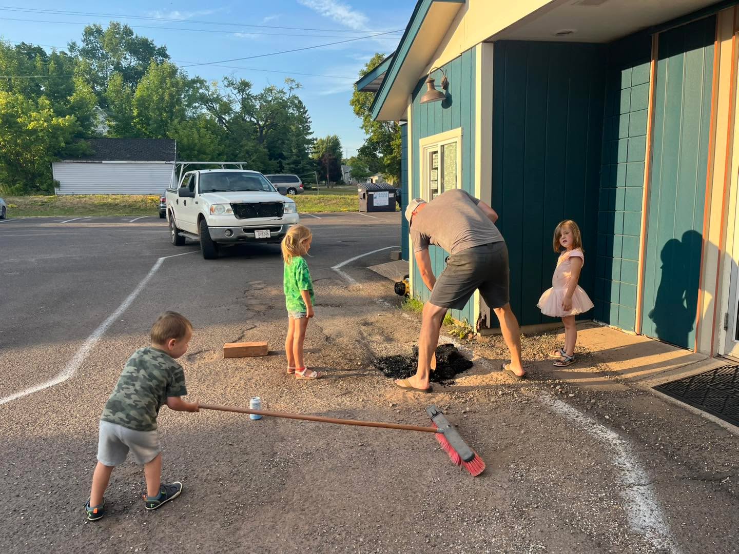 Filling pot holes with the family! We got a few filled and kept the kids entertained. Win, win! We are aware that the parking lot needs some attention and have plans to fix it but it is also a HUGE endeavor for a small business. It’s going to take some saving and planning. We are big proponents of making the most of what you have and focusing on the positives so positives: puddles for kids to stomp in when it rains and people drive slower cause of them so safety for kids jumping in puddles! 😂 In all seriousness though, thank you for your continued support! We love our community!