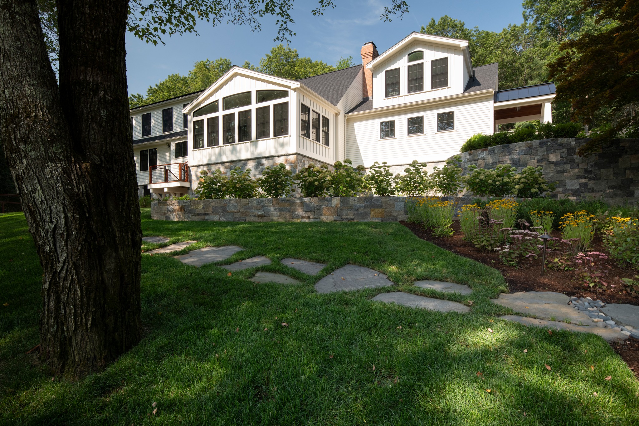 A beautiful highlight from a recent project. We love how these natural stepping stones gently lead you through the lawn, connecting the different spaces of the garden. The stone retaining walls add structure and create beautiful planting areas while helping this sloped site feel more intentional and connected to the main house. A low hedge of FlowerFull Smooth Hydrangeas softens the wall and creates a cozy transition from the front yard to the home. A great example of how thoughtful hardscape can be both practical and beautiful!
@jhs_landscape_const
@dpturf.irrigation
@thomasbuckboroughassociates
#LandscapeArchitect #HardscapeDesign #GardenDesign #LandscapeInspiration #AngieVergeLandscapeDesign