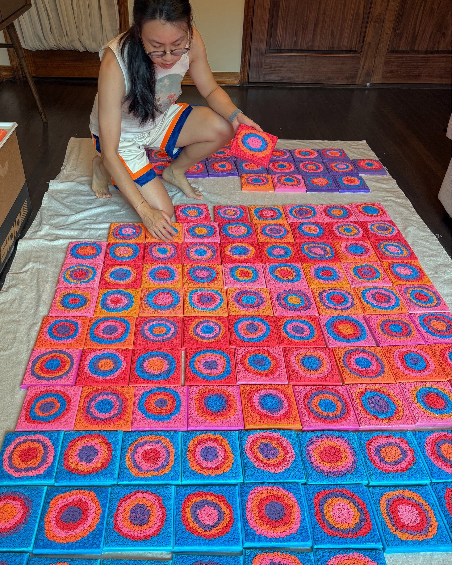 ARTIST INSIGHT | One Work
'I Do Have Choices' began with Jing (Ellen) Xu’s recurring question in moments of feeling stuck: what choices are actually available?
In this 120-part series, Xu uses five colors, each connected to shifting moods, feelings, and inner states. Rather than giving each color a fixed symbolic meaning, she arranges the same five colors in every possible order, allowing them to change relationship, rhythm, and intensity from one panel to the next. The structure is limited, but the variations are many. By placing all of these possibilities in front of the viewer, the work gives physical form to a question that is often invisible or abstract.
Each panel is made by hand with acrylic, modeling clay, and canvas. Xu forms the clay into repeated rings and builds the surface slowly through touch and labor. The system is controlled, but the result is never fully fixed. The clay changes through drying, handling, and time; colors may shift slightly, and each ring holds small differences in size and shape.
The work presents choice not as freedom without limits, but as something found inside repetition, structure, and continued attention.
'I Do Have Choices,' is currently on view in Jing (Ellen) Xu's exhibition on view now at Garrison Art Center through October 4. Gallery hours are Tues - Sun, 10 AM - 5 PM.
In addition, come meet and listen to Ellen for an Artist Talk on Sunday, October 4, at 3 PM during Garrison Craft! Xu will discuss her exhibition 'I Do Have Choices,' including her process, materials, and the ideas behind her modular clay-and-canvas works. The Artist Talk is free and open to the public, it does not include admission to Garrison Craft.
#GarrisonArtCenter #EllenXu #JingElleXu #IDoHaveChoices #ArtistTalk #GarrisonCraft #ArtistInsight #HudsonValleyArtists