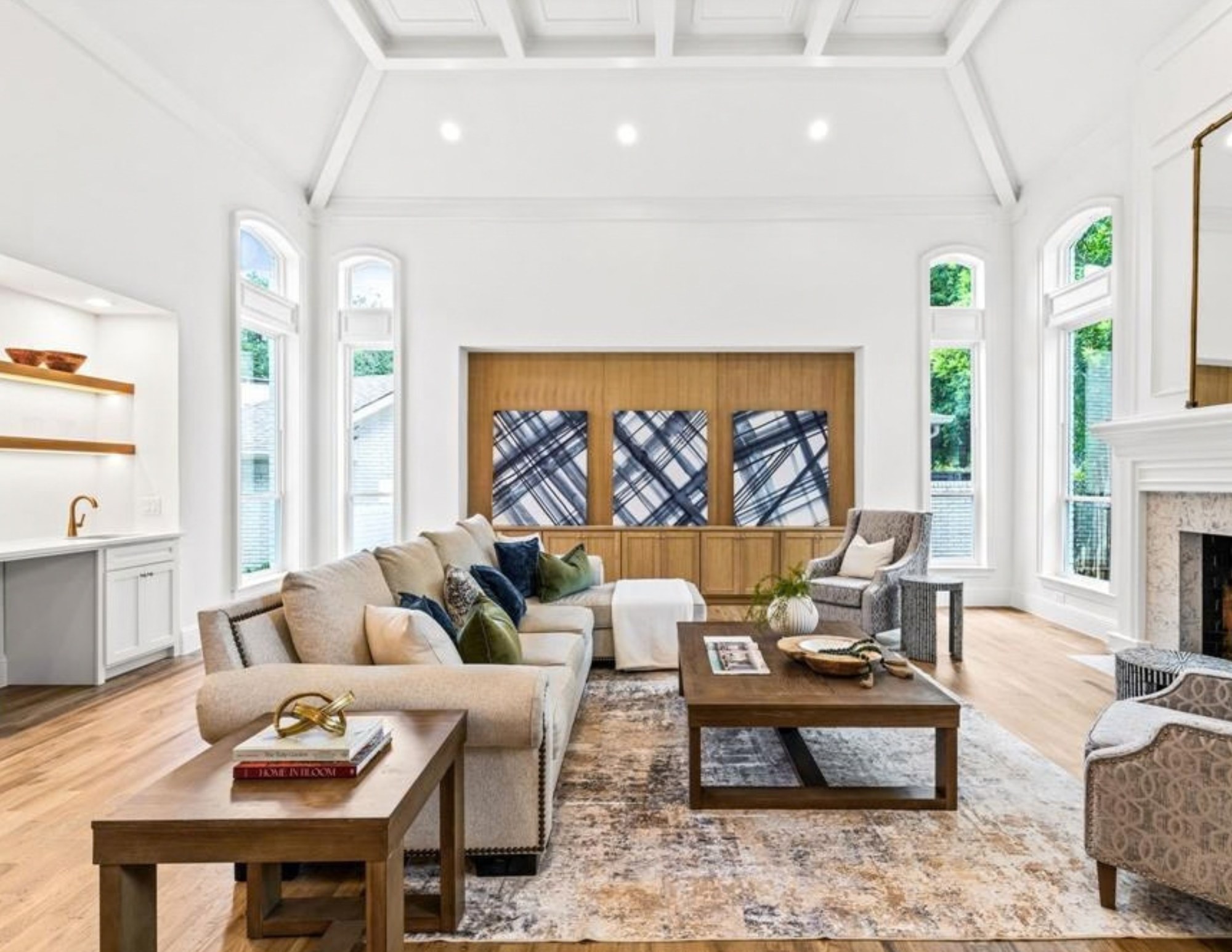 There’s a lot of white in this home, but it certainly doesn’t feel boring. 🤍
Throughout each space, we used warm wood tones, touches of blue and green, pattern, texture, statement art, and thoughtfully scaled furniture to bring warmth and personality into an already beautiful, light-filled home.
That’s one of our favorite things about working with a neutral backdrop: you don’t have to compete with it. You get to layer onto it.
From the oversized art in the living room to the olive chairs tucked into the breakfast nook and those little moments of brass throughout, each detail adds just enough interest while still letting the architecture breathe.
Neutral can still have personality, and this home is a pretty good example of it.