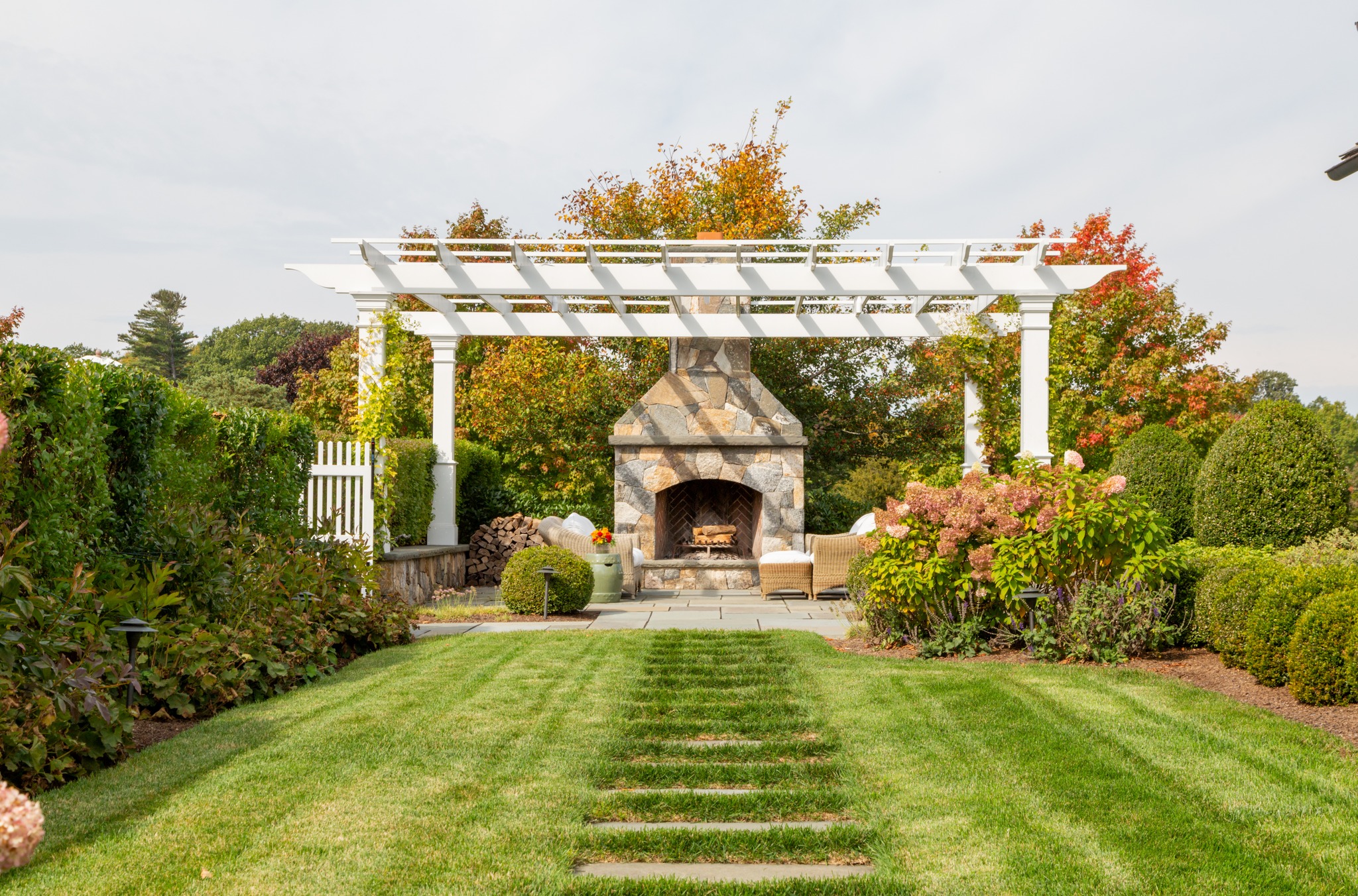 Outdoor living that doesn’t end when summer does. With a wood-burning stone fireplace at the center and a custom pergola overhead, this backyard was built for everything from summer evenings to cozy fall weekends.
Architect: @patrickahearnarchitect
Photography: @taylor.allegrini
#FallonCustomHomes #CustomHomeBuilder #LuxuryHomeBuilder #BostonBuilder #MassachusettsBuilder #NewEnglandHomes #NewEnglandLiving #CustomHomes #LuxuryHomes #OutdoorLiving #OutdoorFireplace #Pergola #BackyardInspiration #BackyardDesign #StoneFireplace #CustomStonework #FallInNewEngland #FallEntertaining #OutdoorEntertaining #LuxuryOutdoorLiving
