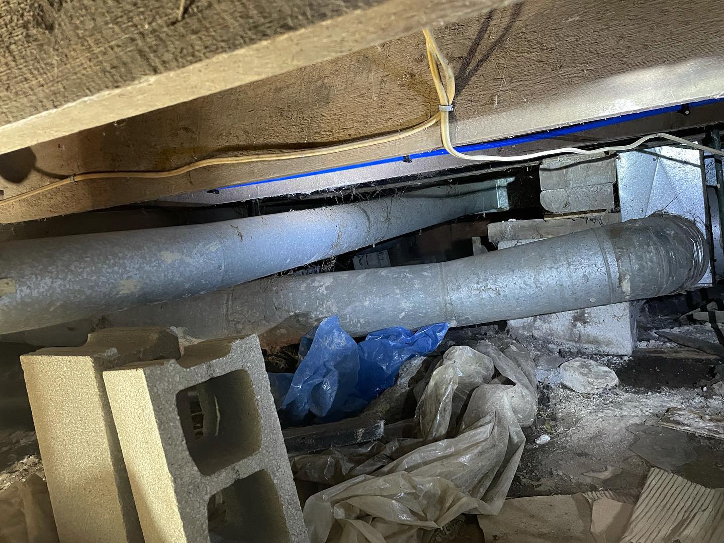 Victorian era house just has a pile of junk wood and blocks next to that vent holding up the entire house! No wonder her floors are sagging.