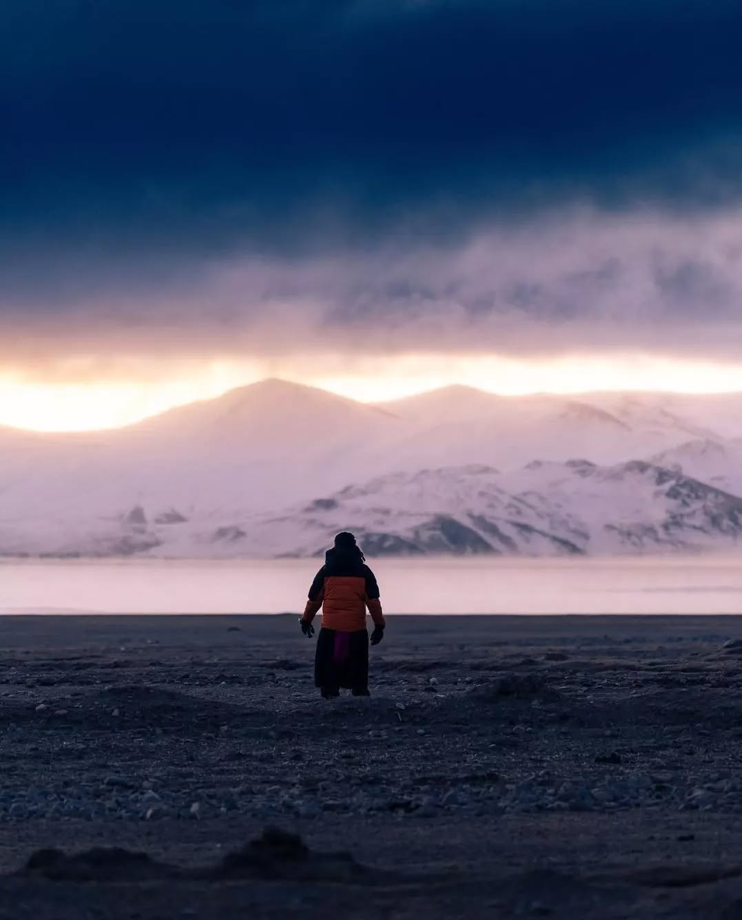 Travel Stories from Ladakh
.
.
"The Coldest Morning of My life - 
It was around 6:15 am, when Waleed asked me if we are going for the sunrise we had planned in our excitement, while sitting in the warmth of the local space heater last night.
The heater had gone off now. The cold had infiltrated the room and the clothes we slept with were no longer enough. Yet, in that moment - I decided that we must go.
We stepped outside the now cold house into what felt like a barrage of ice spikes disguised as the wind. And yet, when we saw the sunrise far from the lake, I took off my gloves to click a picture with my phone. 
In less than 10 seconds, I felt my hands go numb. For the next few hours, they would hurt uncontrollably . And yet, I knew I had to reach the river banks. Because I knew that I was on the verge of seeing something that was probably never meant for any human to see.
It was around -35 Celsius that morning when we reached the river banks. And I saw the clouds meeting the face of the lake and witnessed beauty that I felt I was born to see. We stayed there for 2 hours to see the sun rise. We kept walking non stop to keep the blood flowing. We did whatever was needed to continue witnessing the magic that was happening
.
.
📸Courtesy @waleedtak
#ladakhbackpackers #travelholic #tsomoriri #nubravalley #backpacking #lehladakh #backpackers #wanderlust #spiritualawakening #instagram #nikonindiaphotography #ladakh #likeforlikes #backpackertrails #ladakhdiaries#followforfollow #adventurelover #himalyandiaries #himalayas #ladakh2022 #backpackerstays #nunkun #travelphotography#incredibleindia #follow4followback