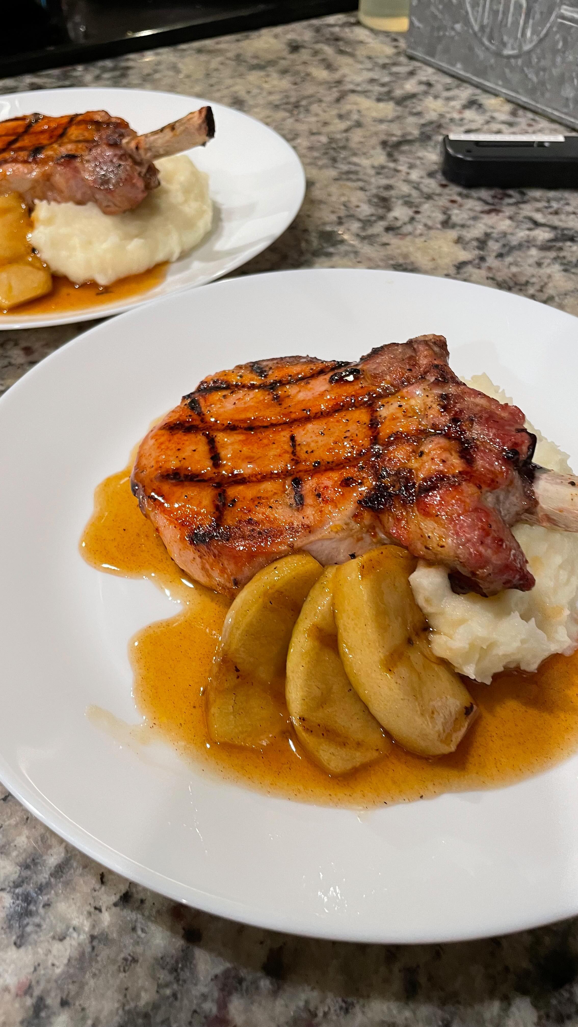 Dinner for two featuring succulent bone-in pork chops paired with grilled spiced rum apples, ignited to perfection! Can we say YUM 🤤