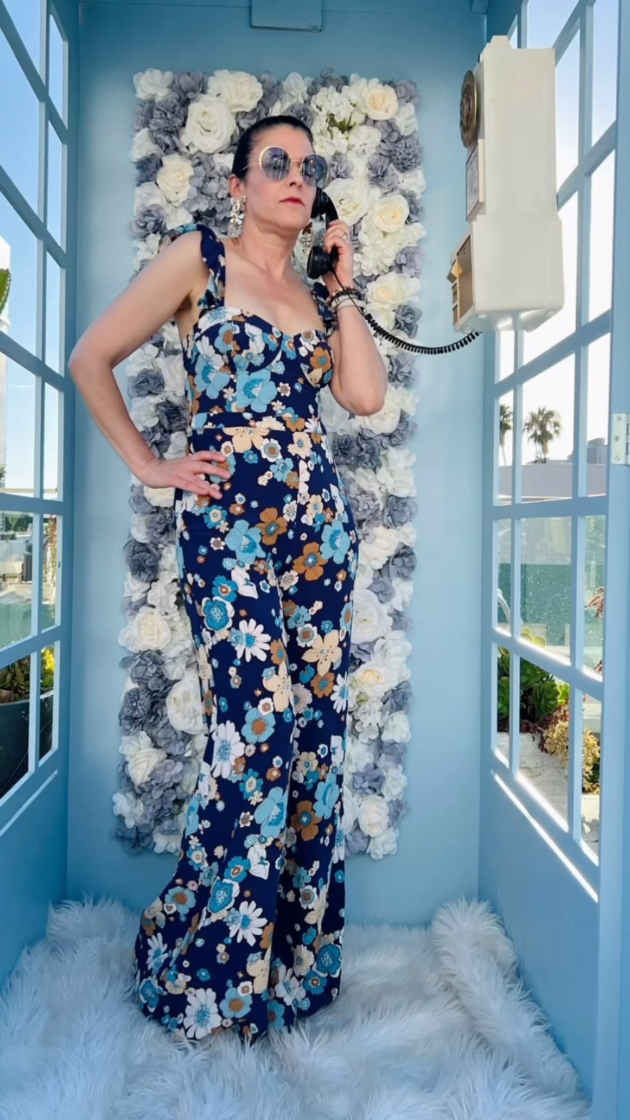 When the outfit matches the prop 💥📞💙🤍
.
.
.
.
.
#poshpartylosangeles #phonebooths #jumpsuitlover #boldprints #midlifestyle #lawoman #poshmarkseller #groovyvibes #summerstyle #partyoutfit #hollywoodnights