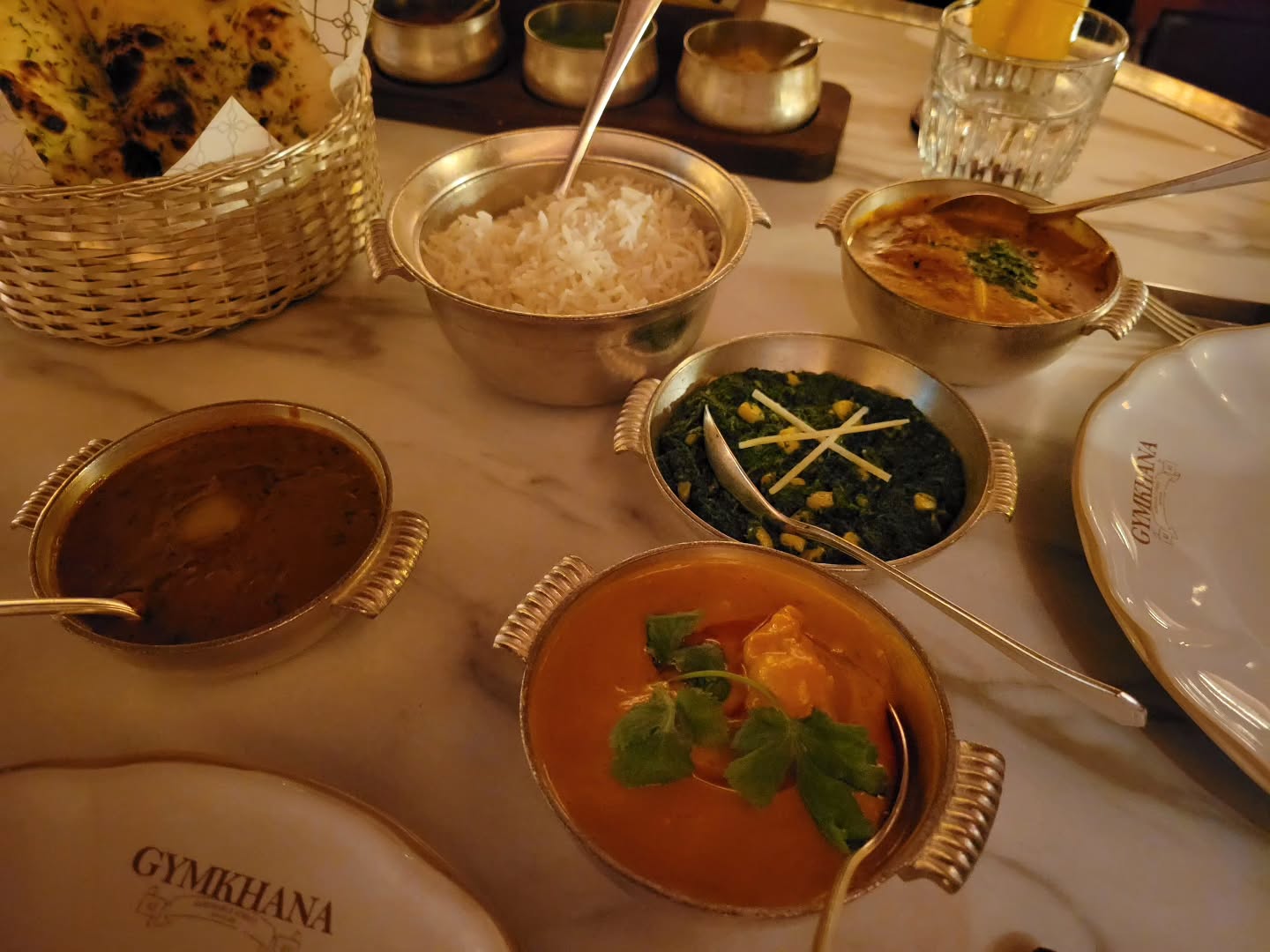 Chicken Butter Masala (Back Right) & Goan Prawn Curry (Bottom Center) Served With: Dal Maharani (Left), Saag Makai (Middle) , Bread Basket & Basmati Rice
@gymkhanalondon #michilinguide #michilinstar #michilinrestaurant #indianfood #gymkhana #masala #chickenbuttermasala #Goat #prawn #curry #goatprawncurry #saagmakai #dalmaharani #londoneats #internationalfood #london #uk #munchandmeandereurope #munchandmeander