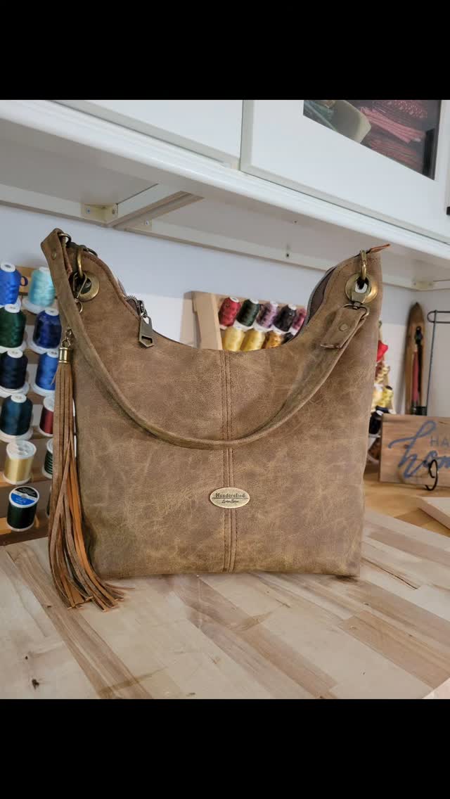 Uptown Swing, pattern by Sew Yours. A jazzy, slouchy, classic hobo bag made out of vegan leather and antique brass hardware. Its cotton interior has 2 slip pockets and 1 zipper pocket to hold all of your personal items. I personally love the tassel!
This one will be available on my website soon.
#stylishbag #hobobag #uptownswing #trendingbags #handcrafted