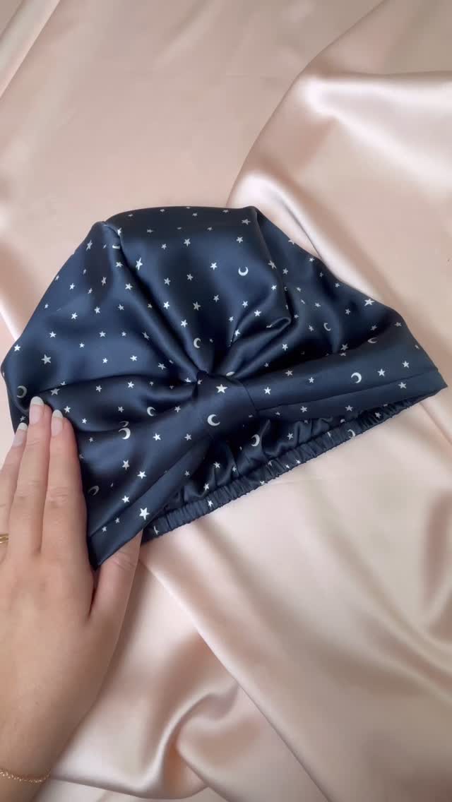 Let’s have a little chat about sleep cap sizing. I recently sewed this custom sleep cap and thought it was a good time to have a talk about me adding another sleep cap size. My current sleep cap is 50cm or 19 ¾” unstretched but the elastic needs a bit of tension to stay on your head so I recommend it for head sizes from 21” and 24” or 53.5cm and 61cm. The maximum stretch is around 64cm or 25 ¼” but just as you need a bit of tension from the elastic to keep the sleep cap on, you don’t want it too tight either!
When sizing I tend to try a sample on myself, my mannequin head and my husband’s head! For reference, my head size is about 54cm or 21 ¼”, my mannequin head is 57cm or 22 ½” and my husbands head is about 61 cm or 24”
So if I made a second sleep cap size, what would you be looking for?
Video description- Jo talks about sleep cap sizes while showing a custom size navy sleep cap with white star and moon print and then compares the size to a pale purple sleep cap