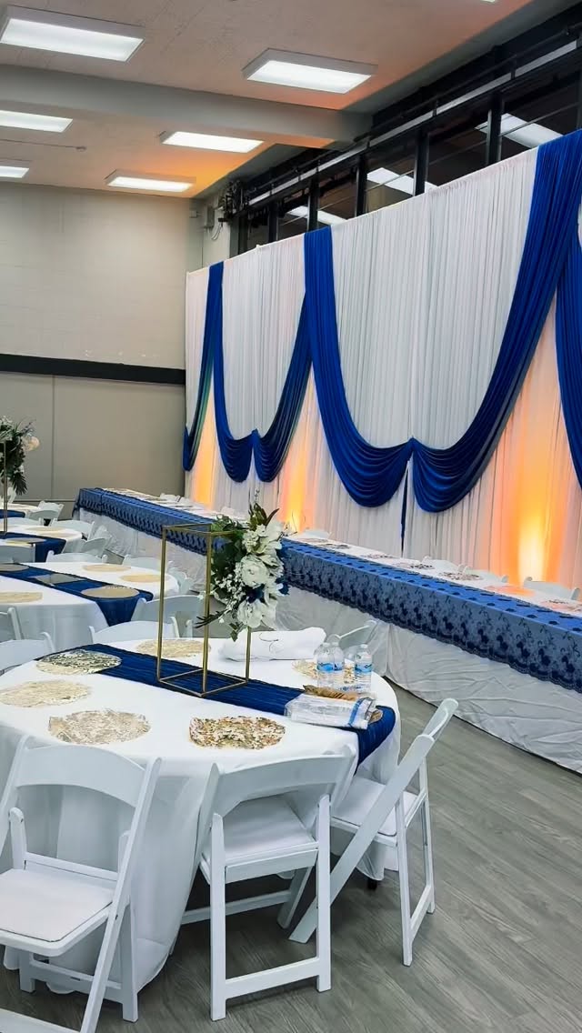 Luxury white interlock draping accented with premium blue and gold fabrics, designed to create an elegant and upscale event aesthetic. Our high-quality draping adds depth, sophistication, and a modern luxury feel perfect for weddings, corporate events, and special celebrations. Clean lines, rich fabrics, and flawless styling that transforms any venue beautifully. 91ft x14 foot tall