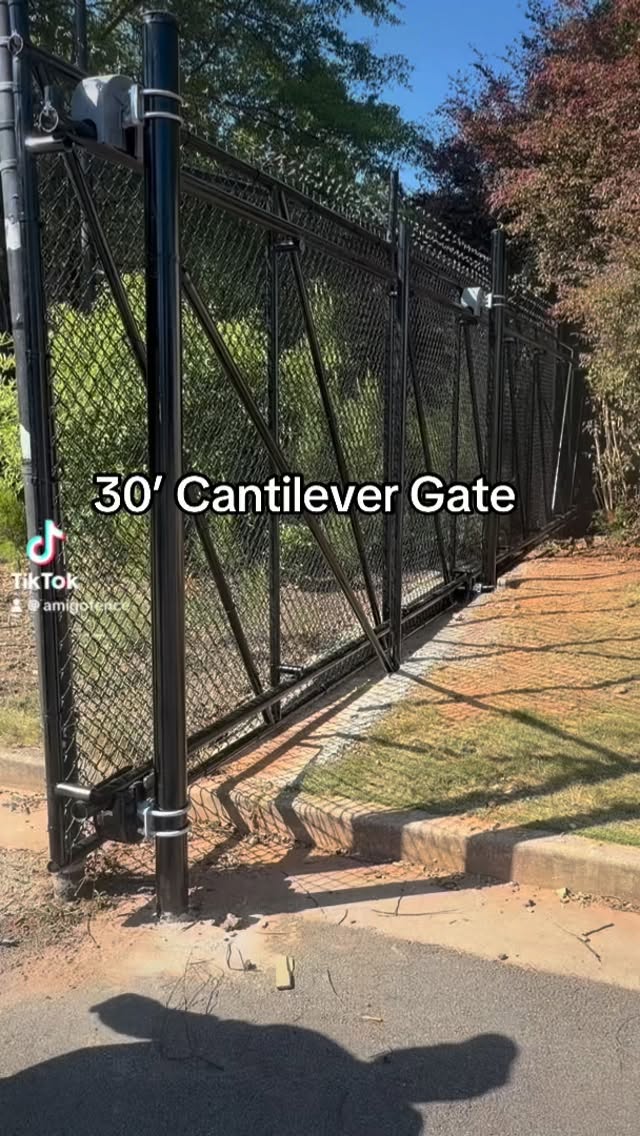 30’ Cantilever Gate installed at Home Depot Warehouse for secure truck access and perimeter protection. Heavy-duty black chain link fence with barbed wire adds extra security, durability, and controlled entry for commercial operations. #amigofenceandstain #fence #fencecompany #fencecompany