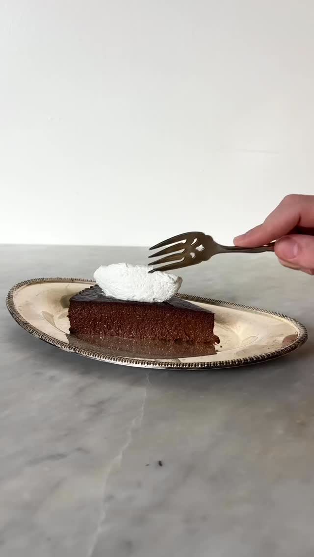 Full recipe below! After several test variations settled on a recipe that reminds me of standing in her kitchen watching and helping her cook for that nights dinner. Super happy with it, I could eat this cake all day long.
Stellas pudding cake (Budino ai ciocolato)
1 Liter milk
25 g espresso (or a teaspoon instant)
100 g sugar
120 g dark chocolate
30 g cocoa powder
100 g Savoiardi
4 eggs
In a sauce pot stir together the milk, espresso and sugar, and bring to a light simmer
Melt chopped chocolate in the milk, and cocoa powder. Whisk to melt. Alternate to a rubber spatula to make sure no chocolate is burring on the bottom.
Crush the Savoiardi cookies into fine crumbs. When the chocolate mixture is back to a simmer, pour in the crushed Savoiardi and whisk again.
Whisk for the first 5 min to make sure all the cookies are dissolved and no lumps are left.
Simmer and lightly boil the mixture for around 15 min, scraping the bottom and whisk frequently until it has thickened into a pudding.
Take off the heat and transfer to a bowl or shallow dish. Place plastic wrap on the surface of the pudding and set in the fridge to cool.
Once the pudding is room temp or cooler, remove from the fridge and whisk in the eggs one at a time.
Heat oven to 375 with a large roasting pan or baking sheet filled with about 1in of hot water. Butter a springform pan and wrap the outside in aluminium foil to prevent water from seeping in. Pour pudding into the pan and bake in the water bath for about 45-50 min or until the cake has a very small wiggle to it but isn’t visible liquid.
Remove cake from water bath and set the springform in the fridge until completely cooled before removing the springform ring. Serve with very lightly sweetened whipped cream and optional maraschino or chandied cherries.
#baking #dessertrecipe #whatsfordessert #chocolatecake #nycbaker