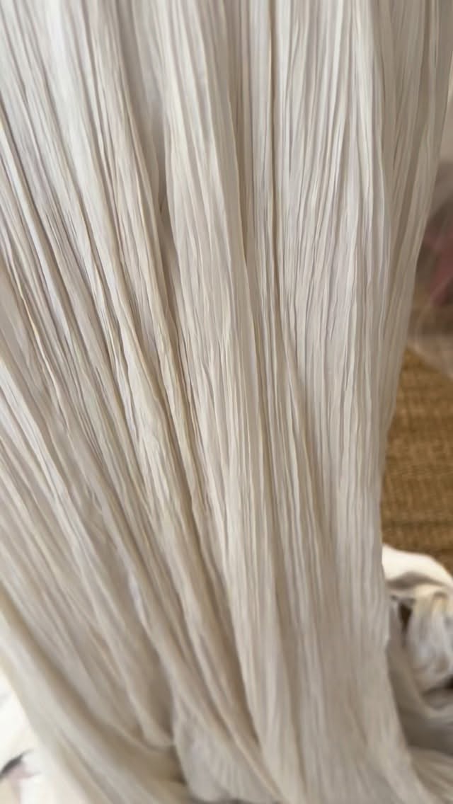 Inspired by the landscape of Nui Chua National Park, Vietnam and the rugged coastline of Vinh Hy Bay, Tiffany’s bespoke gown came together over 12 months of zoom calls between Australia and San Fransisco. Married on the weekend amongst treasured family and friends at the stunning Amanoi Resort, Tiffany’s request at the outset was that her gown would at times look as though it could disappear into its surrounds.
Fluidity and texture were important considerations when coming up with a design and through several iterations we developed a piece that I hope did just that! Tiffany was drawn to 3D embroidery and sculptural forms so I textured silk organza scrim and hand sewed this to the corseted bodice… silk satin was overlaid with delicate silk gimp and fragments of silk tulle inspired by the effect of light reflecting off ocean waves - creating a deconstructed lace that combines the raw with the refined, stark lines against sinuous ones, jagged alongside curve, chaos alongside order. Like nature herself. Hand sewn to the corset is a skirt that I hand pleated and hand dyed in nuanced off white tones that cascades in gentle waves and tendrils and flows into a long train reminiscent of falling water… a dream of a dress to create and a dream of a bride who trusted the process despite being unable to attend in person! Luckily, Tiffany’s future MIL could attend in person - the wonderful Jan translated my at times chaotic thoughts into clear conversation that meant we got there in the end! We couldn’t have done at without her and it was a beautiful and profound example of families uniting. Of the value of ritual and the essence of marriage. I was genuinely honoured to have played a part in the journey.
The final and uniting element for Tiffany was her veil, again hand embroidered with silk gimp and silk tulle fragments I can’t wait to share photos… buy I think I’ll have to do a seperate post just for the veil!!!