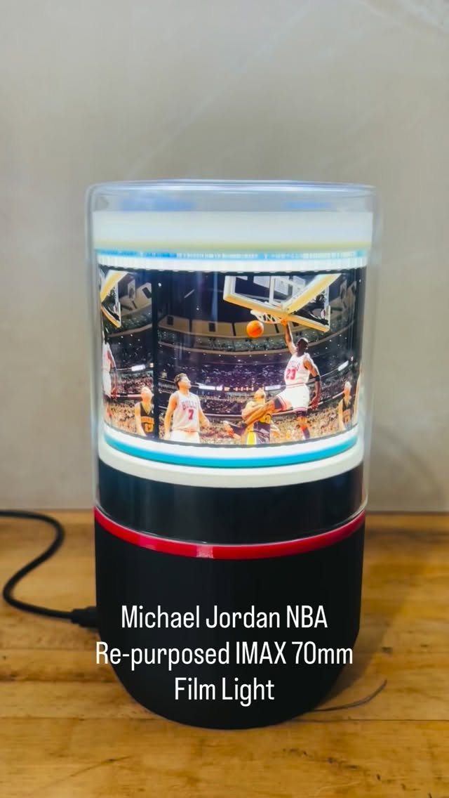 Custom accent light created by re-purposing actual IMAX 70mm film to showcase Michael Jordan of the NBA Chicago Bulls in action. A unique assembly (‘A world’s first!’) holds this large rare film of unparalleled beauty. The base contains an LED & small motor. A protective glass dome is placed over the assembly to protect the film and inner workings. It’s powered by a USB C cable - Crafted in our studio in Ontario, Canada & shipped worldwide.
https://www.cine-light.com/ #michaeljordan #michaeljordanfan