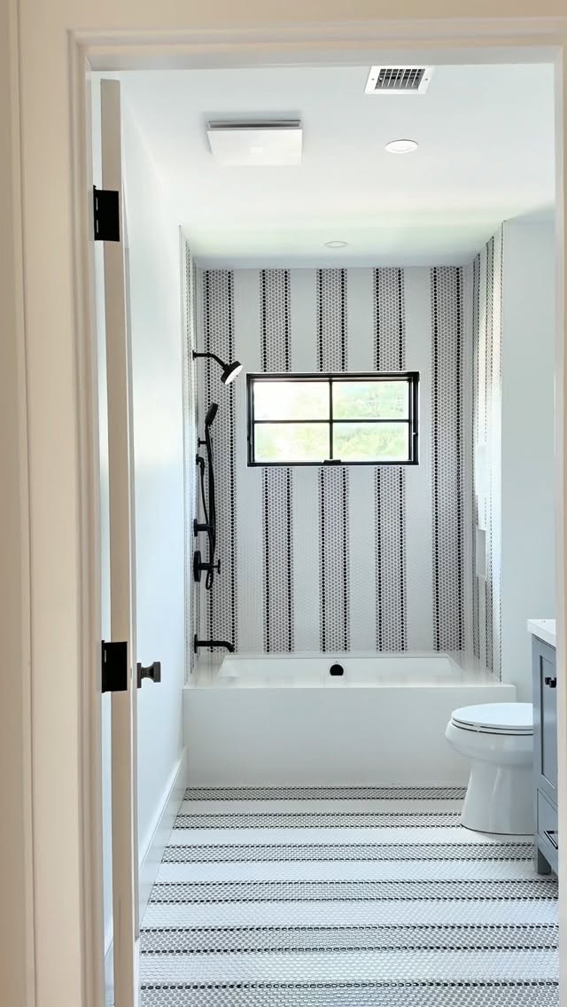 Sometimes, one detail is all it takes to define a space.
At Harbor View Park, a classic penny tile gets a playful twist with a custom striped pattern that continues from the bathroom floor into the shower. This creates movement, contrast, and just the right amount of personality.
#BostonInteriorDesigner #BathroomDesign #PennyTile #TileDesign #BathroomInspiration
