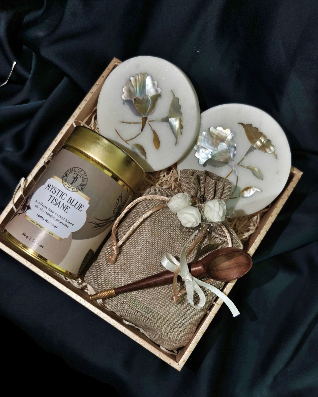A tea jar of your choice, alone with 1-3 tea pouches, a wooden spoon and a set of beautiful marble and mother of pearl coaster to make for a luxurious gift!