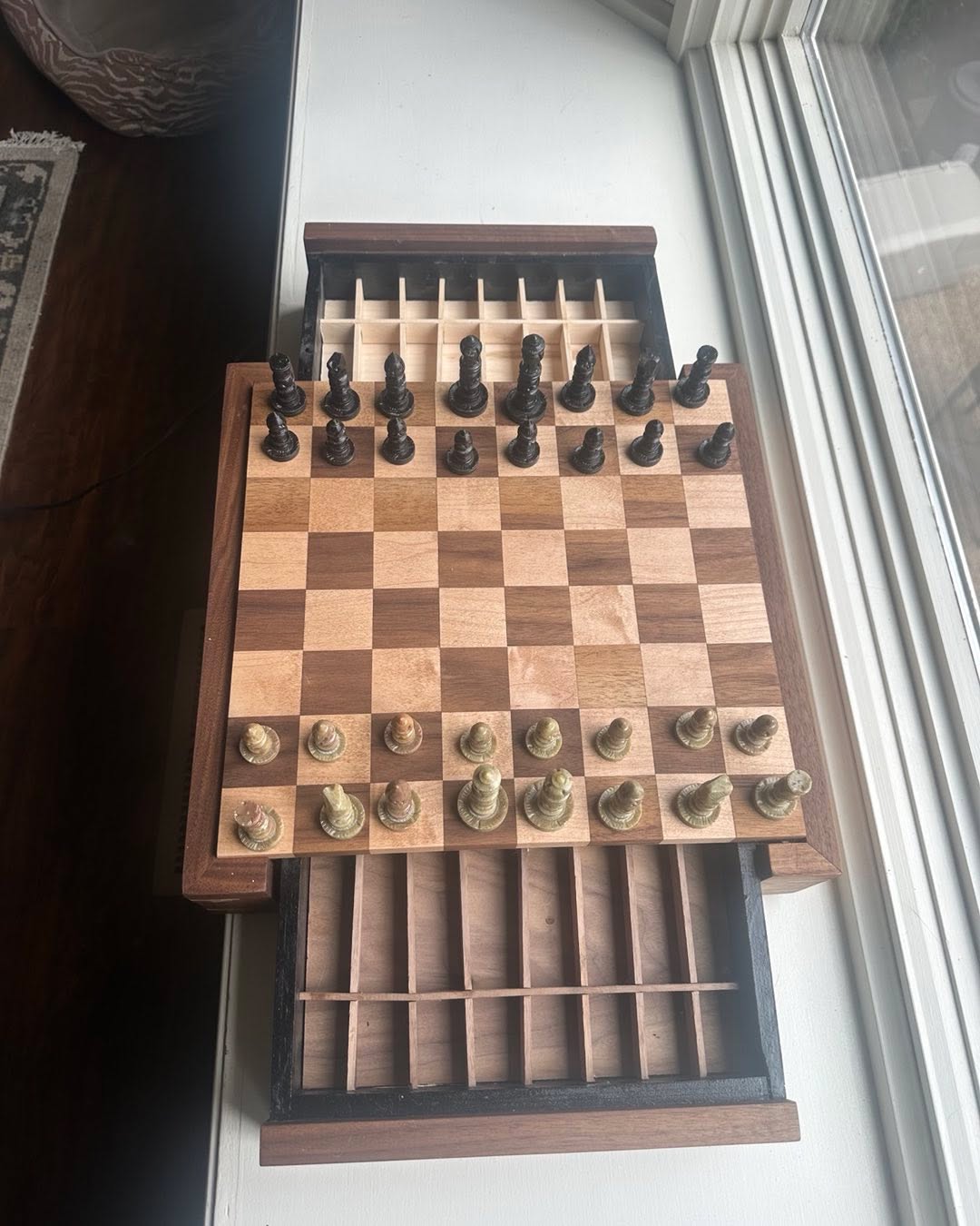 Walnut and maple chess set with drawers for pieces.