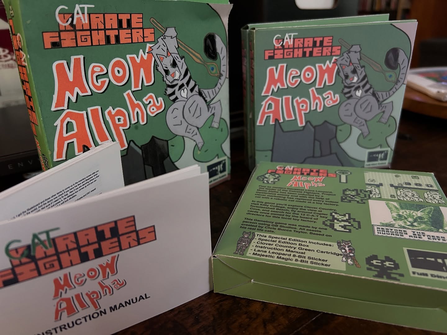 Get a “complete in box” copy of Meow Alpha for Gameboy today!
Limited Physical Edition comes with:
- Clover Country Green cartridge
- Special Edition box
- 8-Bit Majestic Magicat Sticker
- 8-Bit Lana Leopard Sticker
- Exclusive Instruction Manual with Developer’s Log
This home-brew Gameboy game was made by one person and it’s about cats that know karate. Gameplay is Donkey Kong Country meets Legend of Zelda.