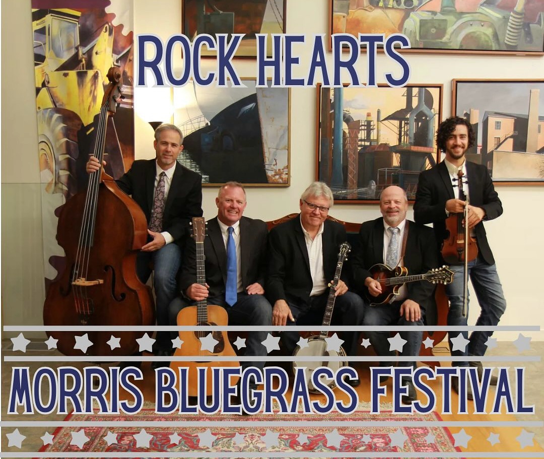 ARTIST HIGHLIGHT – ROCK HEARTS
IBMA Showcase Band
Formed in 2013, Rock Hearts brings together five seasoned musicians from Southern New England who love to sing and pick bluegrass, old country tunes, and seek out tunes from other genres to “bluegrass-ify.” Named an Official 2021 IBMA Showcase Band, the band is enjoying national radio and Chart activity.
Rock Hearts has shared the stage with some of the top bands in the industry including, Del McCoury, Dale Ann Bradley, Michael Cleveland & Flamekeeper, Jonathan Edwards, Danny Paisley, The Gibson Brothers, Dan Tyminski, the Seldom Scene, Larry Sparks, and many more. The band consists of founding member and banjo player, Joe Deetz, lead man and guitar/vocals, *Alex MacLeod, the newest Kentucky Mandolin endorsed artist, *Billy Thibodeau, bassist, Rick Brodsky, and fiddler/2023 IBMA Mentor of the Year nominee, *Austin Scelzo. @rock.hearts.bluegrass @morrisbluegrassfestival @southfarms #ctbluegrass #newenglandbluegrass #ctmusicfestival