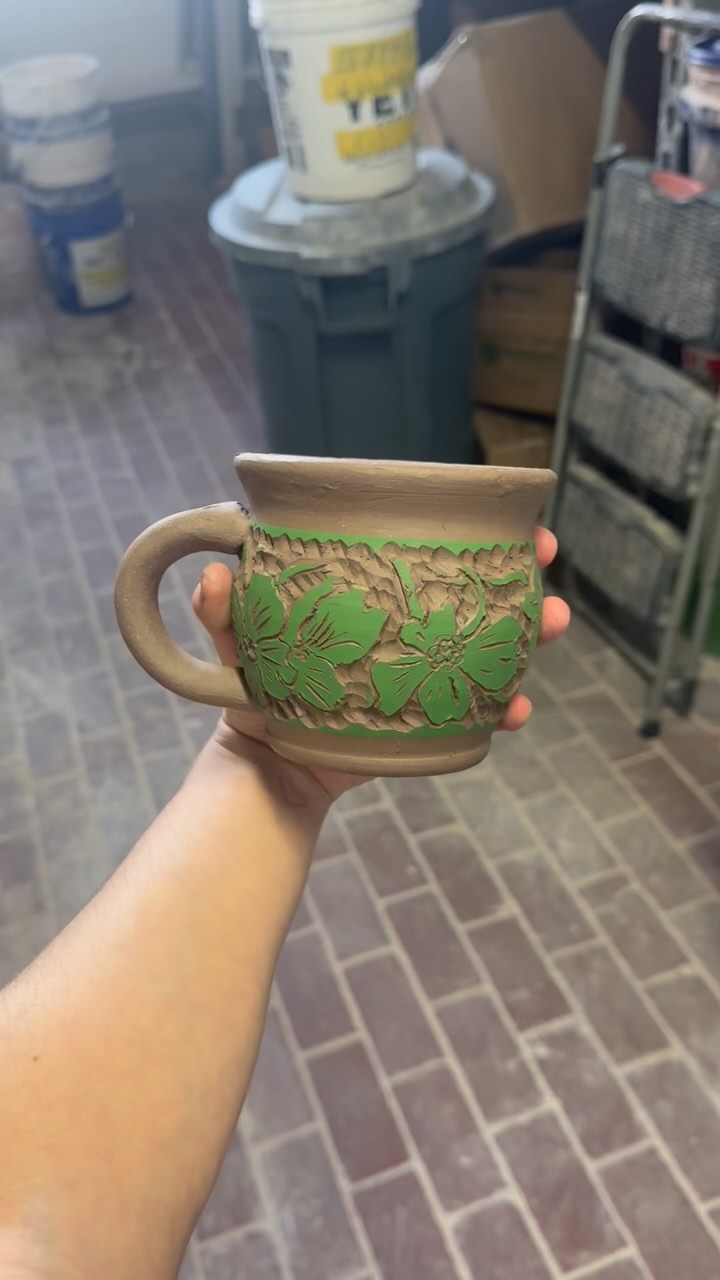close up on some mugs that are currently cooking in the bisque kiln