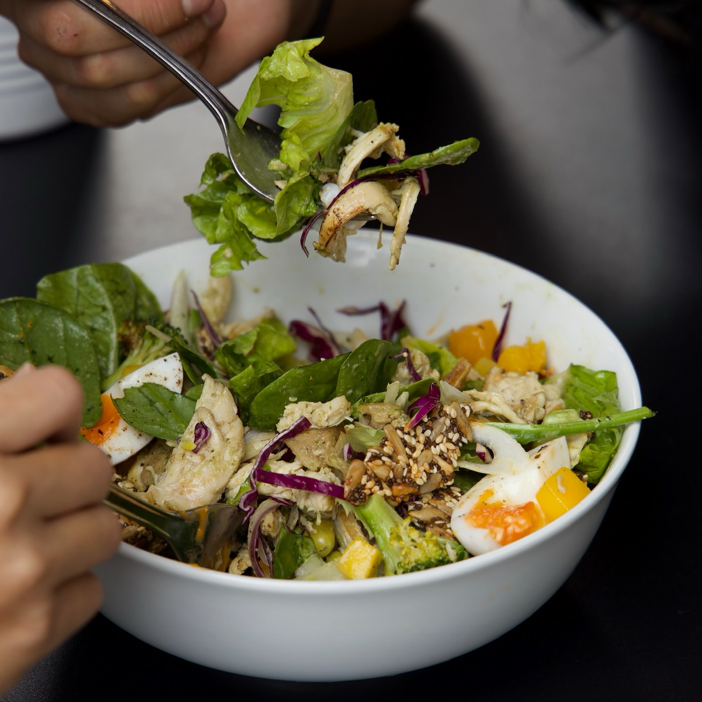 Shredded chicken, jammy egg, crisp salad greens, tangy basil dressing, sweet mango... Simple, but it hits.