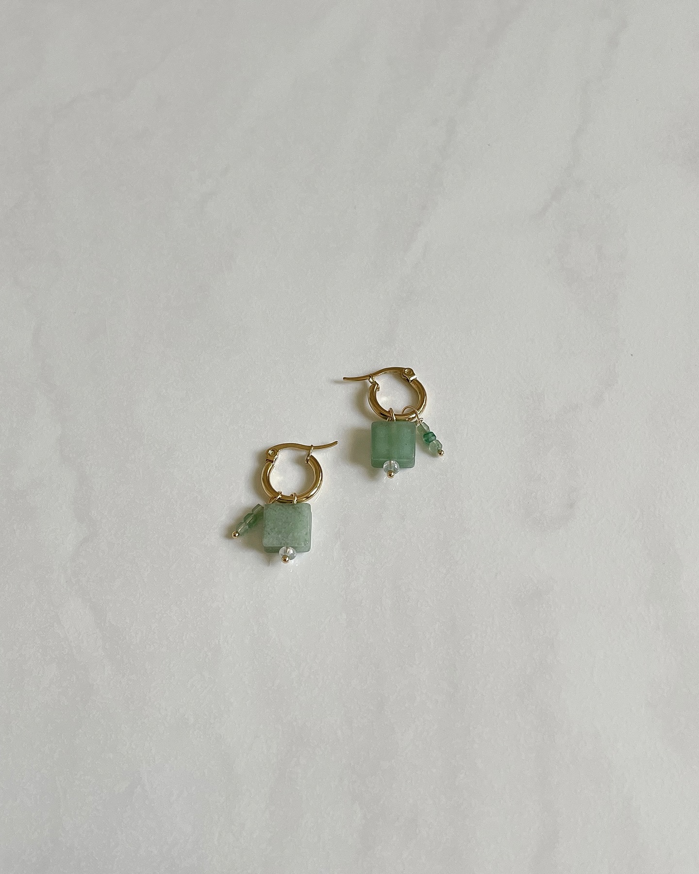 FLOW. 💚 18k gold plated stainless steel earrings with aventurine charms that you can easily take on and off and wear in different ways.
Green Aventurine is a comforter, heart healer and stone of prosperity. It reinforces leadership qualities, decisiveness, and promotes compassion and empathy. It encourages perseverance, stabilises one’s state of mind, stimulates perception and enhances creativity. It neutralises all sources of electromagnetic pollution, settles nausea and dissolves negative emotions and thoughts. It brings well-being and emotional calm. A good all-round healer.
https://www.jellek.si/product-page/flow