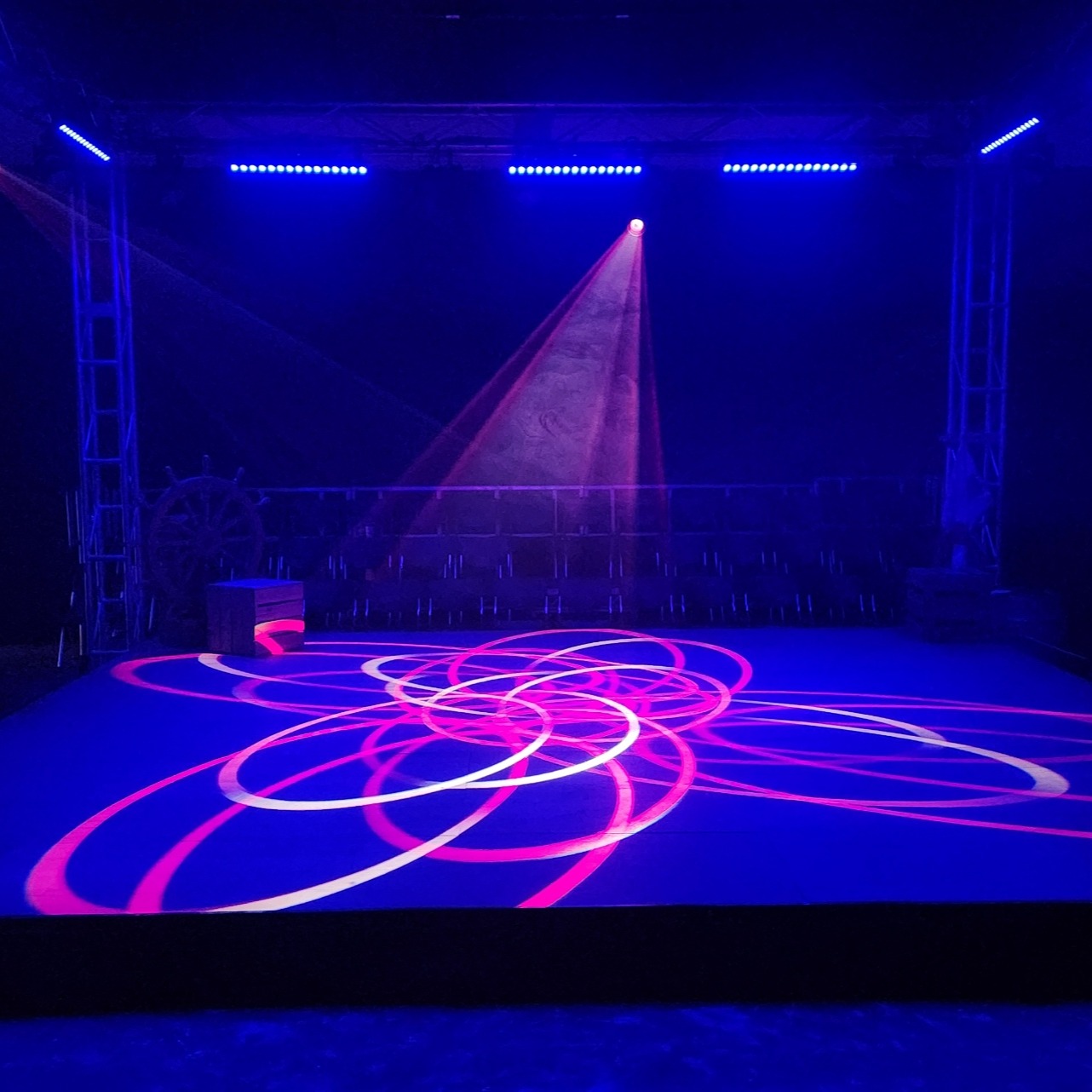 Transforming a standard school hall into an atmospheric performance space.
The Hall was decked out with a 6m x 6m Truss Cube Structure to support most of the lighting equipment as well as props used throughout the show.
There were also 4x truss verticals in each corner to light the entrances and exits.
The lighting Rig consisted of
- 8x Ayrton Mistral TC's
-12x Martin Mac Aura's
- 16x ShowPro Fusion Bar QXV's
- 16x Chauvet Colourdash Quad7's
- 1x Unique 2.1 Hazer
Clear Systems also supplied
72m of 6m High Drape.
49 Stage Decks for the seating risers and centre stage and a 4-way kit of Wireless Comms.
Lighting was programmed by our in-house staff and oversaw student operation throughout the season.