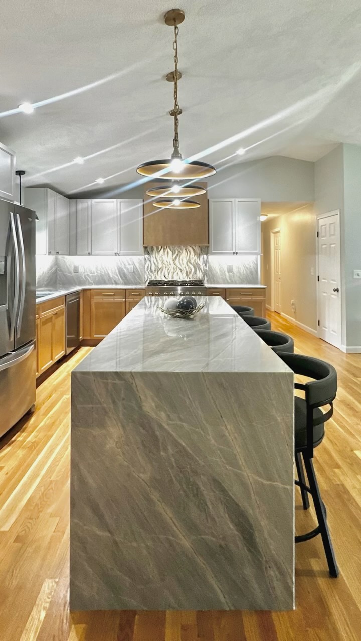 Our goal was to take an original, not very functional, circa 1978 kitchen- with small angled island (see last photo), and transform it by expanding the kitchen space, using a tri-tone color motif inspired by a mountain lake, as well as adding ample counter space and a built in hutch.
The most beautiful blue-grey quartzite stone was used for the countertop and backsplash; featuring a glass mosaic tile accent beneath the wood hood and on the center of the hutch. The sleek pendant lights are aligned along the center line of the island and the range/hood, offering a bit of symmetry to the design.
Technically not quite finished, but in punch list mode— good enough to snap some pics though! 📸
#riinteriordesigner
#kitchenremodel