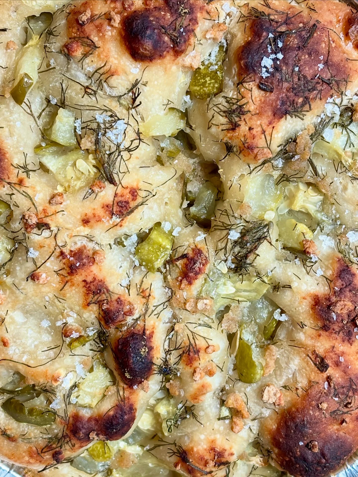 ✨Introducing this week’s star bake.. we absolutely made sure there was extra so we could devour one ourselves.. the DILL PICKLE FOCACCIA! This tear-and-share style baby is the perfect warm weather bread. Filled with fresh dill from the garden and only the best pickles from @clevelandkitchen topped with some sourdough breadcrumbs, fresh grated parm, and a little flakey salt.. it’s probably one of the best things we’ve ever put out into the universe. If you didn’t snag one this week, your chance for next week opens up tomorrow at 10am! Make sure you’re signed up for our hotplate text notifications through the link in our bio 😎 #supportyourlocalbaker #clevelandbaker #clevelandbakery #sourdoughbaker #clevelandsourdough #olmstedtownshipohio #olmstedfallsohio #valleycityohio