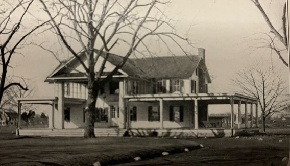 In September 1923, a few prominent RVC businessmen signed a 10-year lease (with an option to buy) on 212 acres of the combined Henchell and Vincent Farms in the northern section of the Village to build The Rockville Country Club. Former Village President (today’s mayor role) David Longnecker was named president. Longnecker’s home was adjacent to the property and still stands today (see prior story on 205 DeMott). The club property was “L” shaped and ran north 4,000 feet from the corner of DeMott and Long Beach, west through woods to Hempstead Ave, and had 1,200 foot of frontage on DeMott Ave.
Plans for construction of the course began with 2.5 acres assigned for 10 clay and grass tennis courts, a renovated clubhouse (at a cost of $25,000) and 18 holes of golf. The incorporation plan included a member cap at 100, annual dues of $150, and shares of stock at $250 each. The existing farmhouse would be renovated to become the clubhouse.
The organizers hired famous club architect Deverau Emmet to design the course. Emmet was quoted as saying, “The grounds are most ideal and difficult to duplicate.” The clubhouse renovation included verandas on all sides for spectator viewing of play. The putting green would be located in front of the clubhouse. Emmet designed over 150 courses around the world including Congressional, Garden City, Cherry Valley, Huntington Crescent, Bethpage Green, Eisenhower Red, Engineers, Seawane, and Glen Head.
The groundbreaking ceremony took place on October 29, 1923 with much fanfare, with RVC Village and Town of Hempstead officials each taking a turn with the golden shovel. Former village officials and other prominent men including David Longnecker, Dr D. N. Bulson, Edwin Wallace, and John Carl, the President of the First National Bank of RVC.
Longnecker was quoted as saying, “We don’t know how many wealthy clubs there will be on the South Shore, but this one will be the best.”
The Rockville Country Club held its opening round and celebration on July 4, 1924 for the first 9 holes. The second 9 holes opened in 1925. In 1959, the club rebranded as “The Rockville Links Club” and the name still stands today.