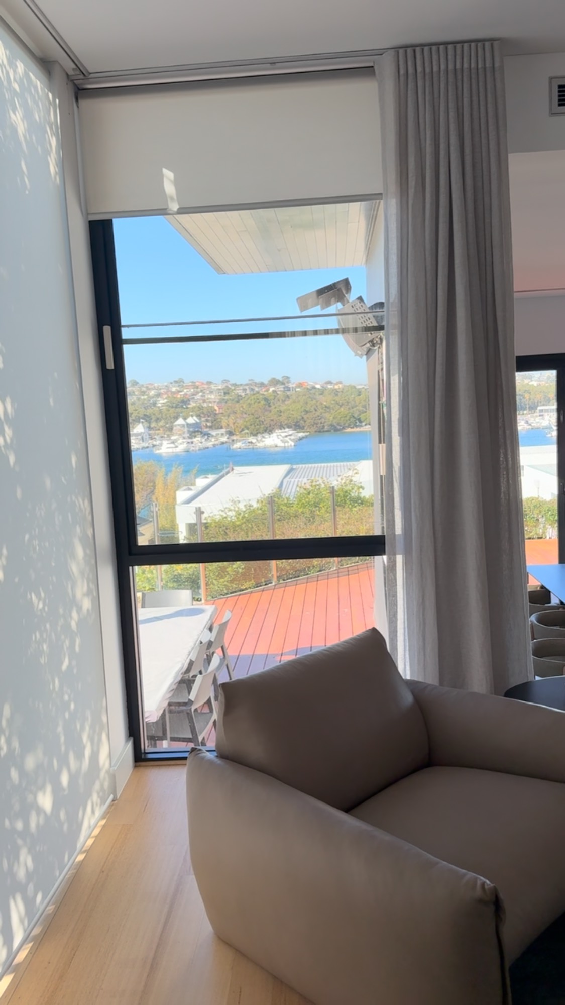 Translucent roller blind behind a line sheer S Wave curtain. Interior project for @statuogroup_ | Window Treatments @windowstudio | #curtains #windowstudio #windowtreatment #curtainsdesign #blinds #perthcurtains