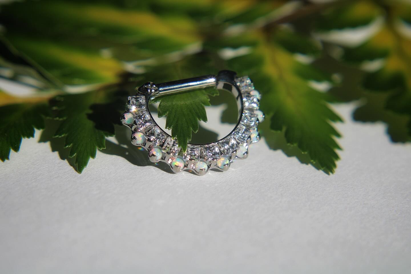 Absolutely stunning clicker with cz’s and white opals