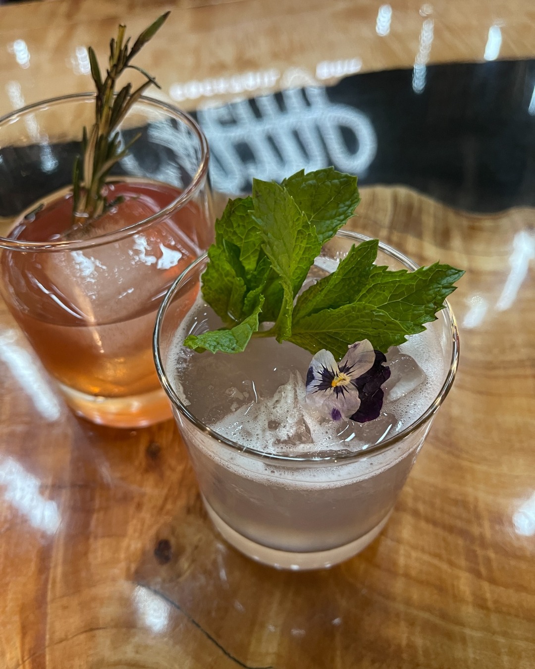 CAMP Cocktail Bar dropped three new cocktails. One’s lavender-infused and light like late summer. One’s garnished with an edible flower that’s almost too pretty to sip. And one’s a bold, upgraded take on the classic old fashioned.
Perfect for pre-gaming trivia, pairing with your favorite eats, or just kicking back and sipping something solid.