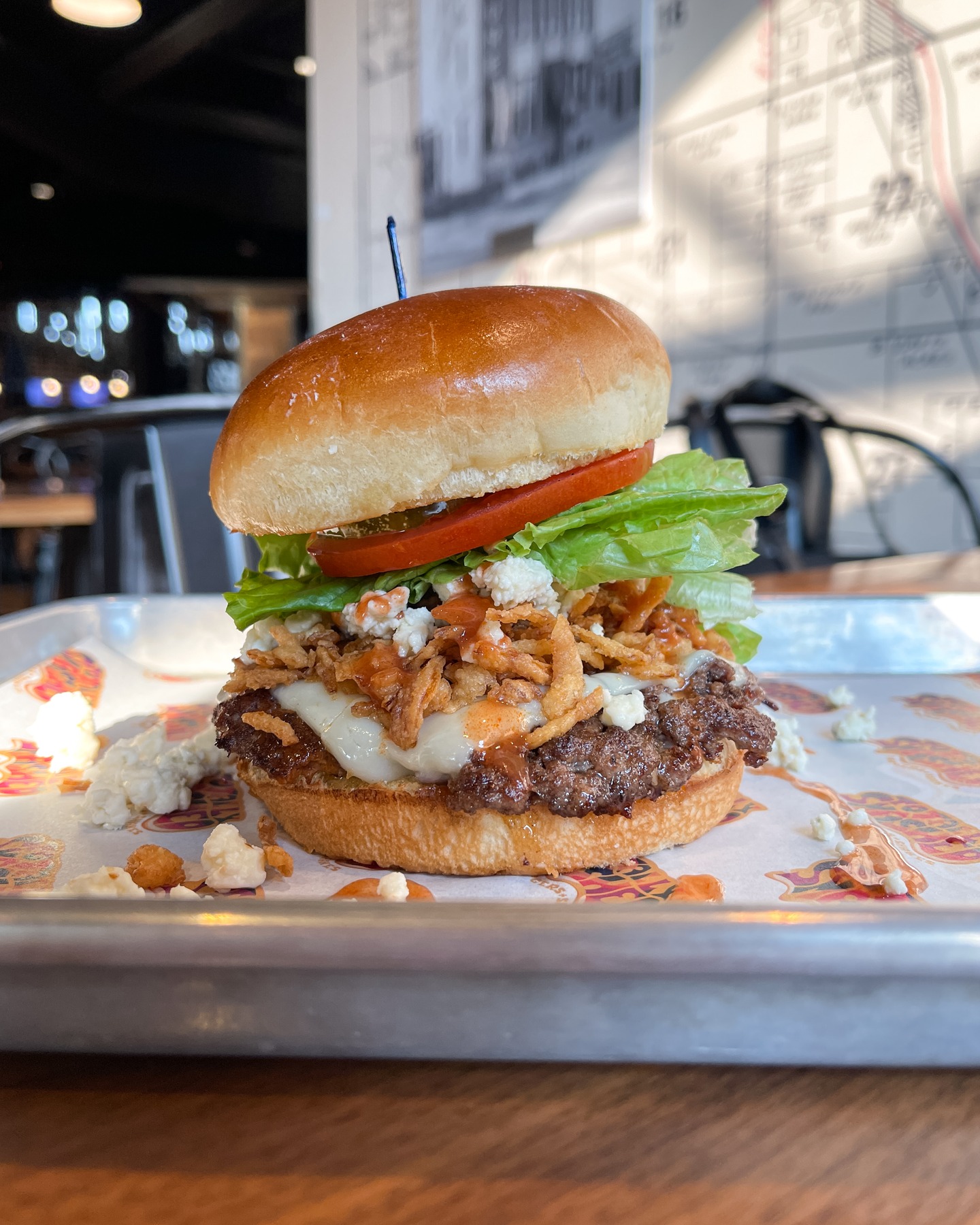 This one comes with a warning label. The Blue Buffalo is loaded, tangy, spicy, and unapologetically messy, in all the right ways. It’s the kind of burger you eat with two hands and zero regrets.
Available now at Totally Smashed. Here for a while, gone when it’s gone.