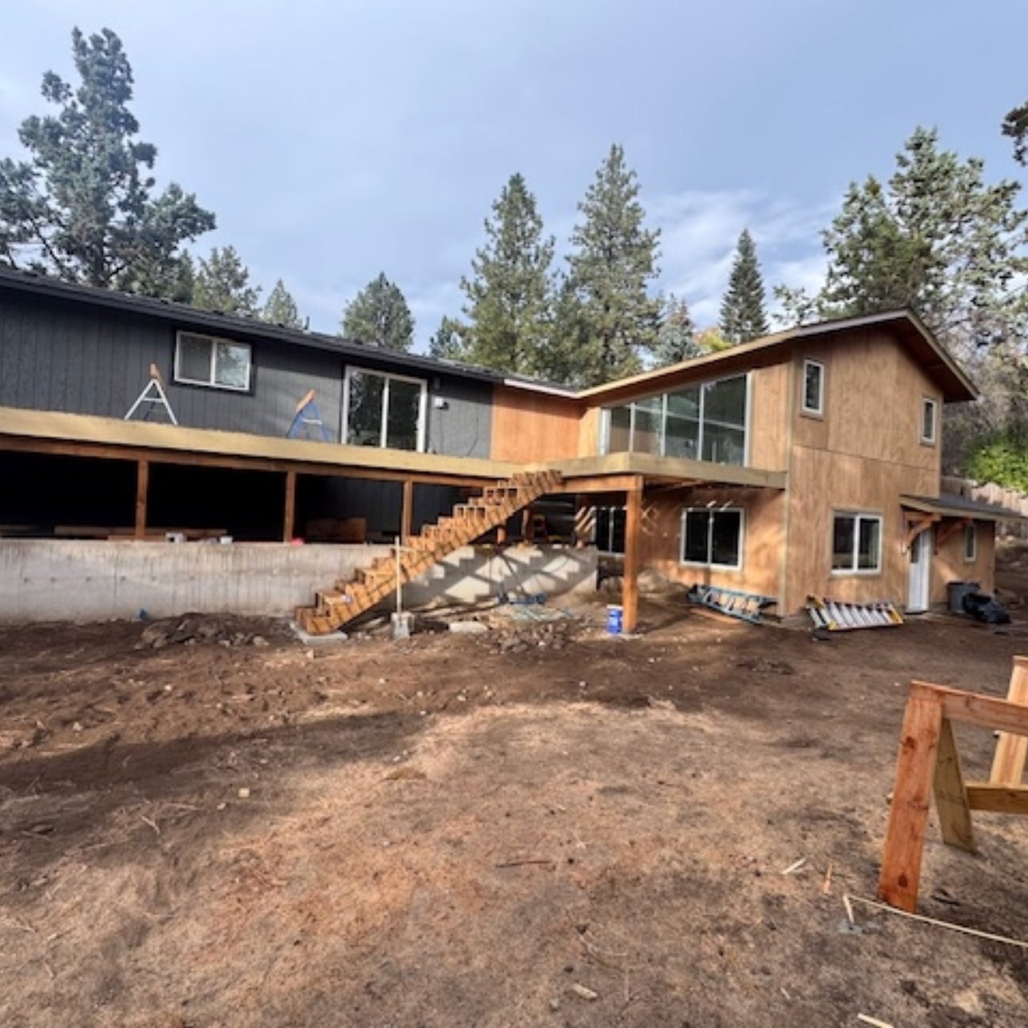 Construction is nearing completion on a 921 SF 2-story addition to a ranch home in Bend, OR.
The site is complex and has a serious slope at the backyard which allowed for the new lower level bedrooms and living space.
The back corner of the house was shored up as the foundation was removed and replaced for the addition work.
The addition at the main level seamlessly connects to the outdoors with a large expanded deck.
One of our more complex additions to date!
#bendoregon #residentialdesign #homeaddition #home #homeexpansion #deck #indooroutdoor #pnwarchitecture #shoring #grading #retainingwalls #sliderdoors #t1-11siding #familybusiness