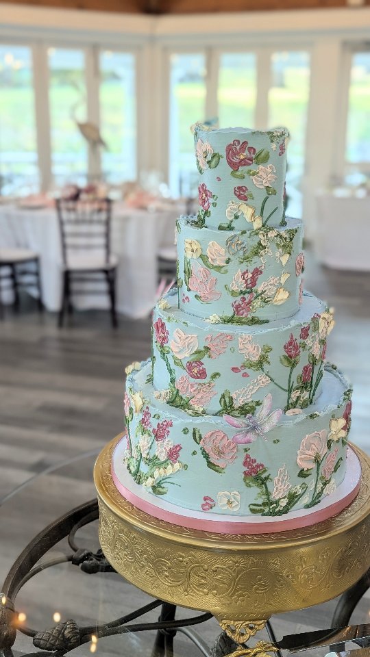 ✨ A touch of Parisian romance in the Virginia countryside ✨
This dreamy dusty blue buttercream wedding cake was hand-painted with soft florals and adorned with delicate dragonflies — a true work of art inspired by French elegance and nature’s whimsy. Surrounded by golden cranes, floating water lilies, and decor in shades of pink, mauve, magenta, and gold, it was the perfect fairytale moment at the beautiful Airlie Resort. 💙🌸🐉
#ParisianWeddingCake #ButtercreamArt #DustyBlueWedding #DragonflyCake #LuxuryWeddingCakes #AirlieResortWedding #TheCakeBee #WeddingInspiration #ElegantWeddingCake