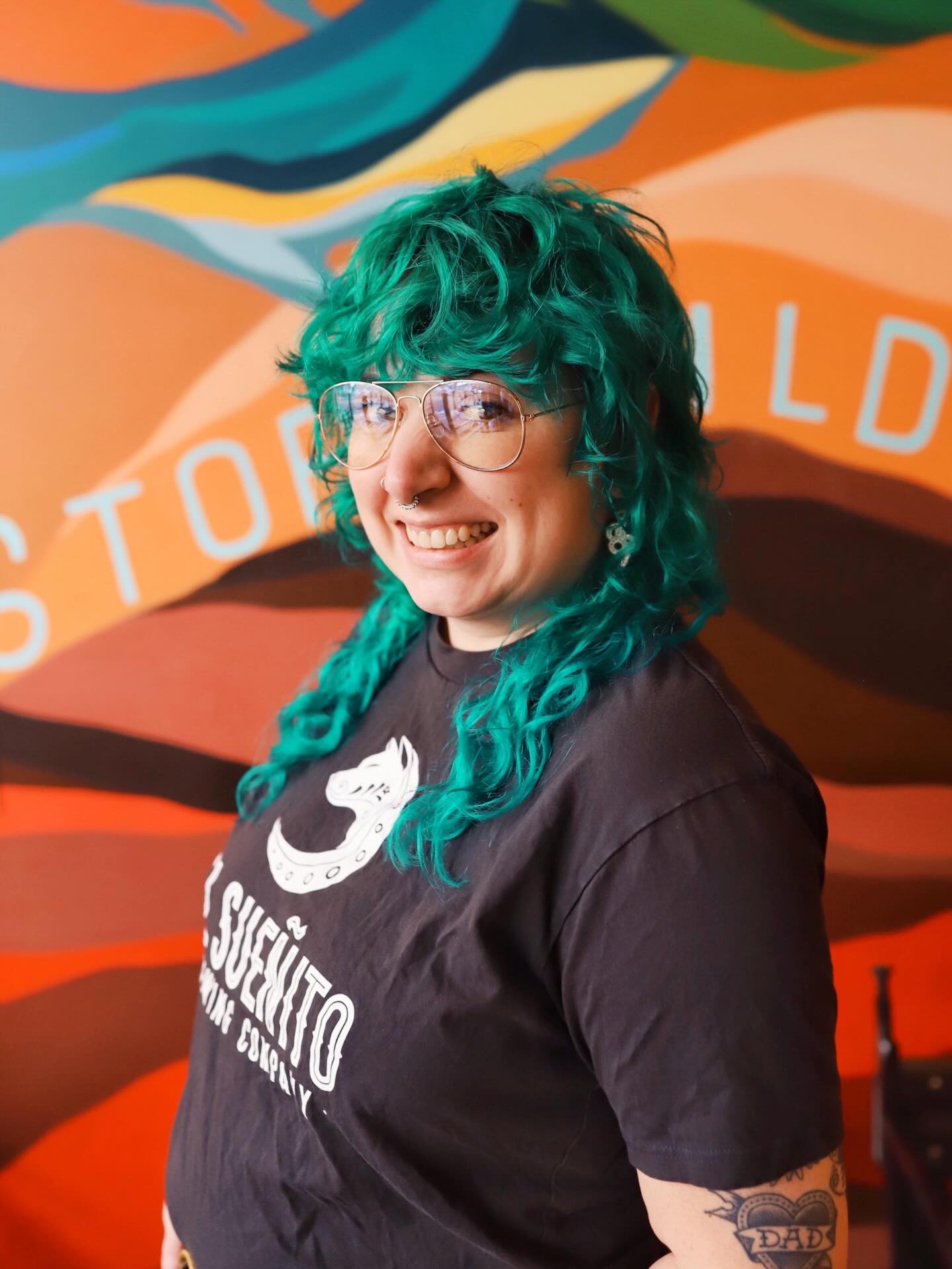 This is Kiersten, sometimes referred to as K around her inner circles. If you have been in Bellingham for a few years, you probably have seen her face at your local watering hole or here at Sueñito. Kiersten is a lover of many things including dogs, Underbergs, floating with friends in the sound, really good cocktails, the Oxford comma, and Fleabag. K is also a badass in many areas of her life and carries a ton of expertise and experience under her belt. She has years and years of experience in the beverage industry in particularly, the beer industry. Want to have a beer sensory competition? She is your gal!
Three years ago Kiersten became our first official hire for our Bellingham location, taking on the role as our Assistant Operations Manager. We were looking for someone who employees could feel relatable to and respect as a building manager. We wanted a seasoned building manager to help us get this beast off the ground — we had no idea what we were doing and we needed someone to help us along the way. K has proven to be the person we needed and we are so grateful we made this hiring decision. Now as Operations Manager for our Bellingham location, Kiersten continues to lead and grow our flagship brewery location. From creative event ideas to phenomenal and witty social media content (have you seen the Pantone post yet?!), Kiersten continues to help El Sueñito remain a vibrant queer community space for everyone.
We are so happy to be able to call Kiersten our OM and also our friend. We are grateful for her leadership and we are so happy she has chosen to make El Sueñito her workplace for the last three years. We raise our glass to badass womxn & femmes like Kiersten who work across every industry in our communities. We raise our glass to the servers, the hair stylists, the teachers, doctors, builders, painters, firefighters, and creatives who inspire us to be good, to take care of each other, be ourselves, and most importantly to have fun, drink good beer and not take life too seriously.
Happy 3rd anniversary Kiersten!
See more on pinned comment below: