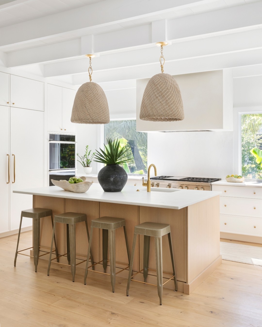 A bright & airy kitchen on Sullivan's Island šæ Our goal was to give our clients the modern kitchen they desired while honoring the character of this historic home (check out that gorgeous original ceiling!). We kept the palette neutral and the lines sleek, adding warmth with white oak, woven pendants, and brass hardware.
