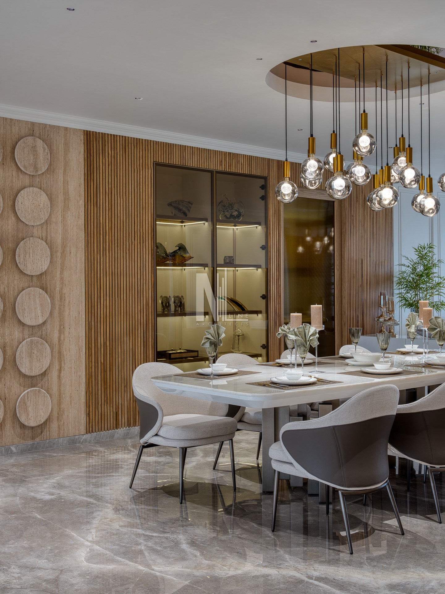 Where texture becomes the true storyteller of the dining space.
A seamless blend of travertine cladding, circular sculptural plates, and vertical fluted wood frames the dining area with an understated elegance. The back lit crockery unit adds a gallery like glow, while the metallic chandelier anchors the table in warm ambience.
A curated balance of form, material & mood, crafted to elevate everyday dining into an experience. 🍽✨