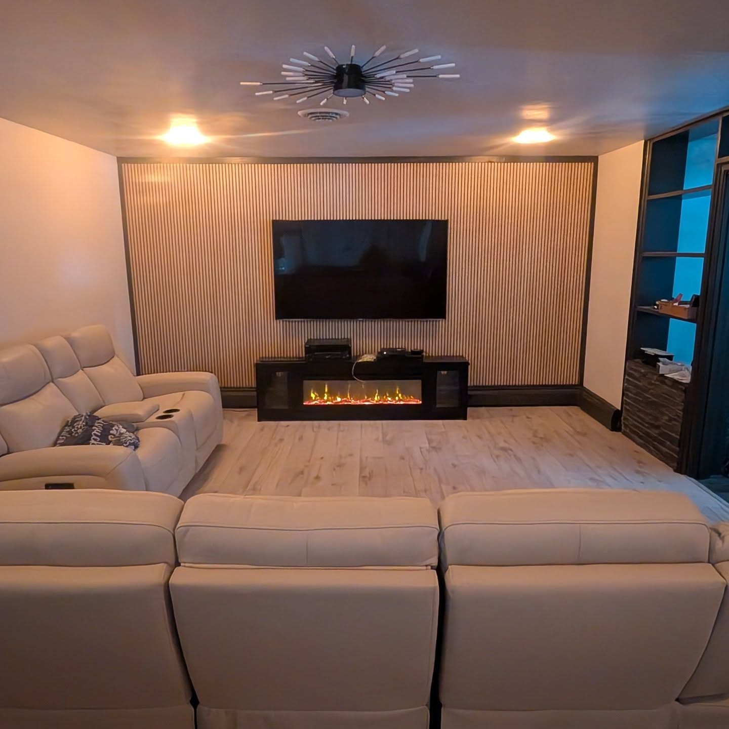 The living room renovation is now nearly complete. We love a good accent wall, so we decided to bring the warm, deep tone of the dining room wainscotting into the trim and bookshelves. It is accented by oak raised panels on the far wall. They are a similar shade to the oak floors in the kitchen and dining room, finishing a cohesive design theme throughout the full home remodel.